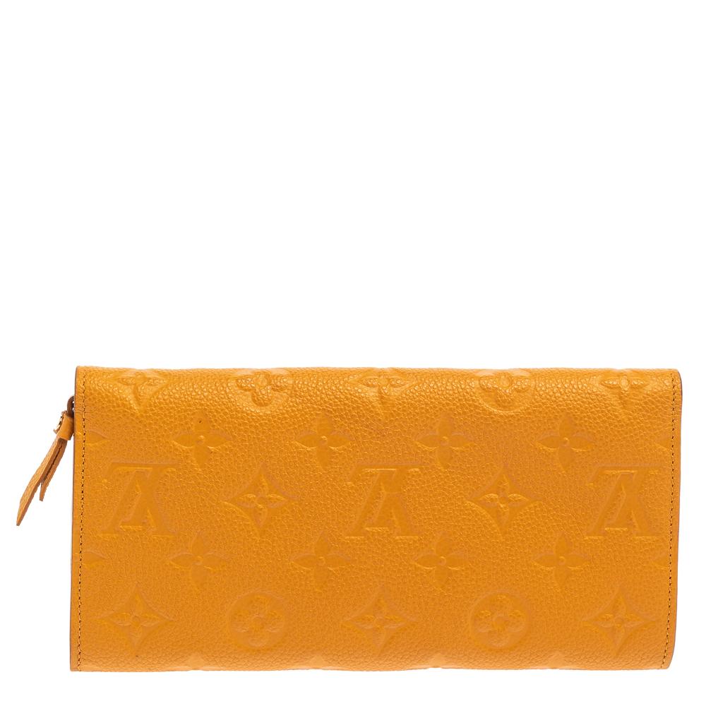 Stylish wallets are a closet must-have! This yellow Curieuse wallet from Louis Vuitton is styled like an envelope and is crafted from Empreinte leather. This sleek wallet comes with multiple card slots and a removable zipped pouch. It is perfect for