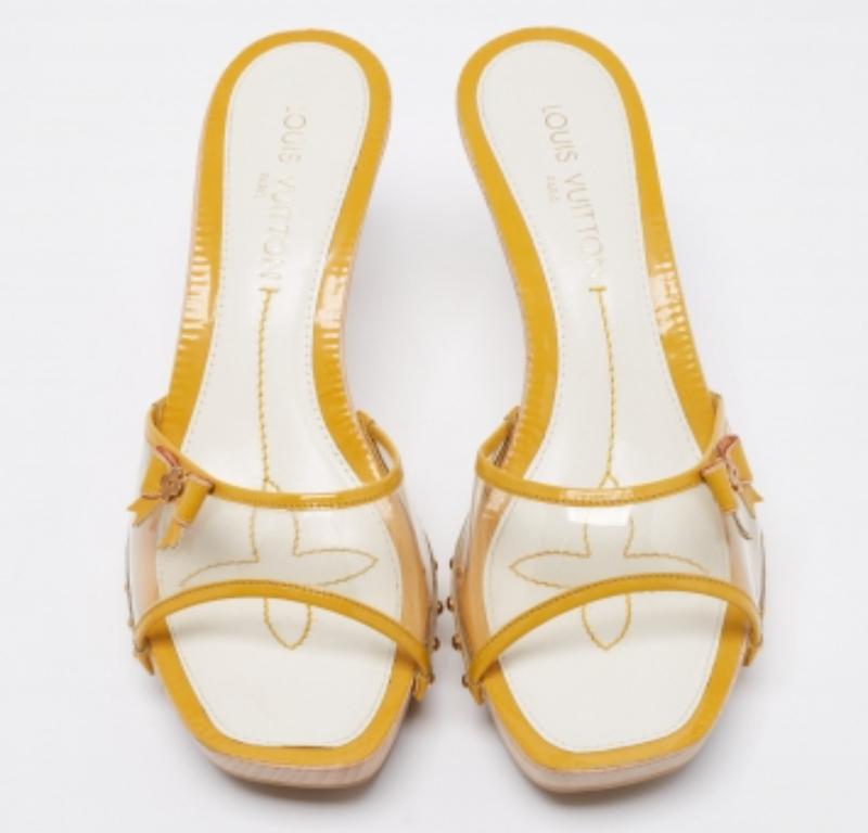 Pretty and minimal, these Louis Vuitton sandals tops in highlighting the feminine charm. Crafted from patent leather, they feature open toes, PVC vamps, and delicate bow details on their sides. Elevated on 10 cm heels, they come with leather-lined
