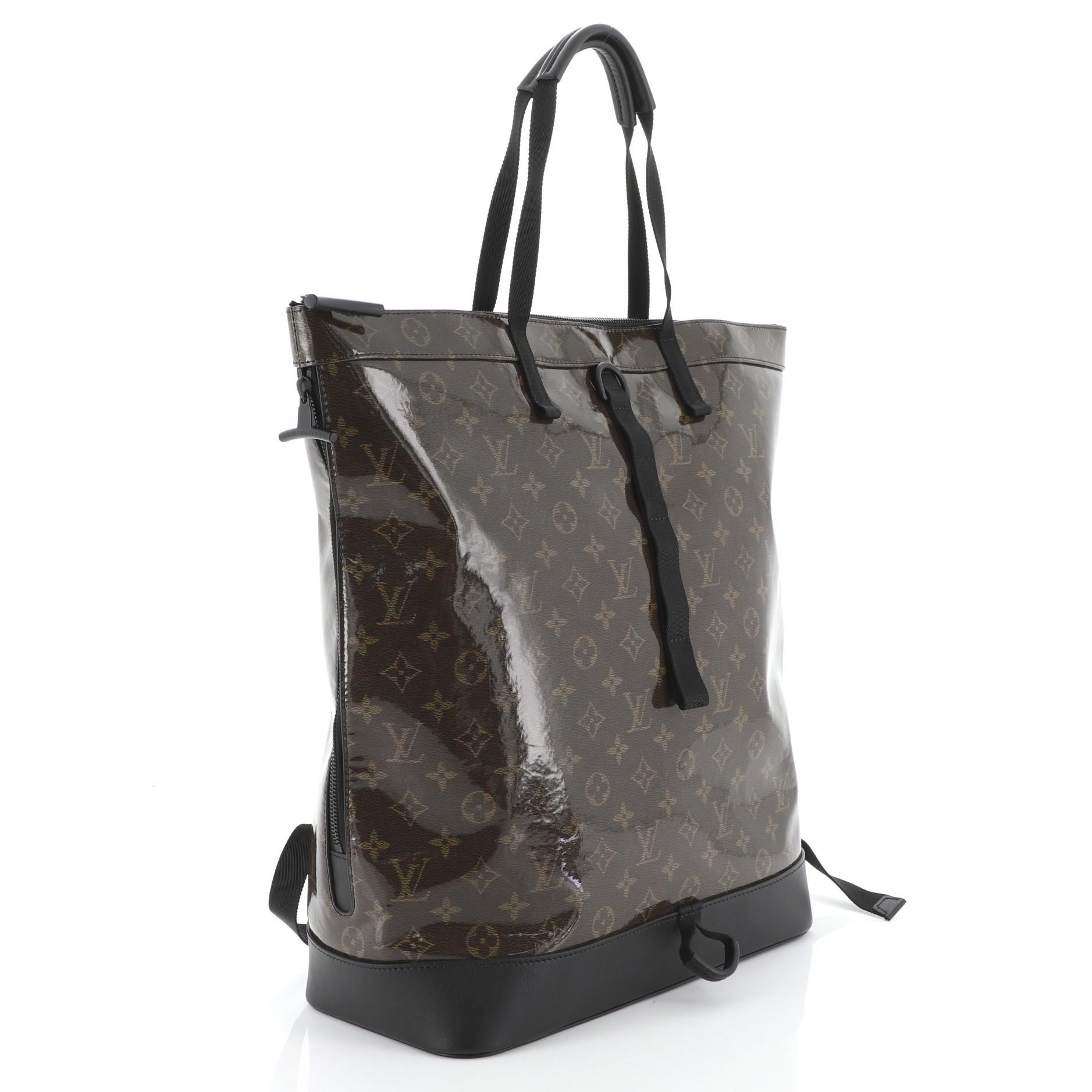 This Louis Vuitton Zipped Tote Limited Edition Monogram Glaze Eclipse Canvas, crafted from brown monogram glaze eclipse canvas, features dual top handles, adjustable backpack straps, exterior side zip pocket, and black-tone hardware. Its zip closure