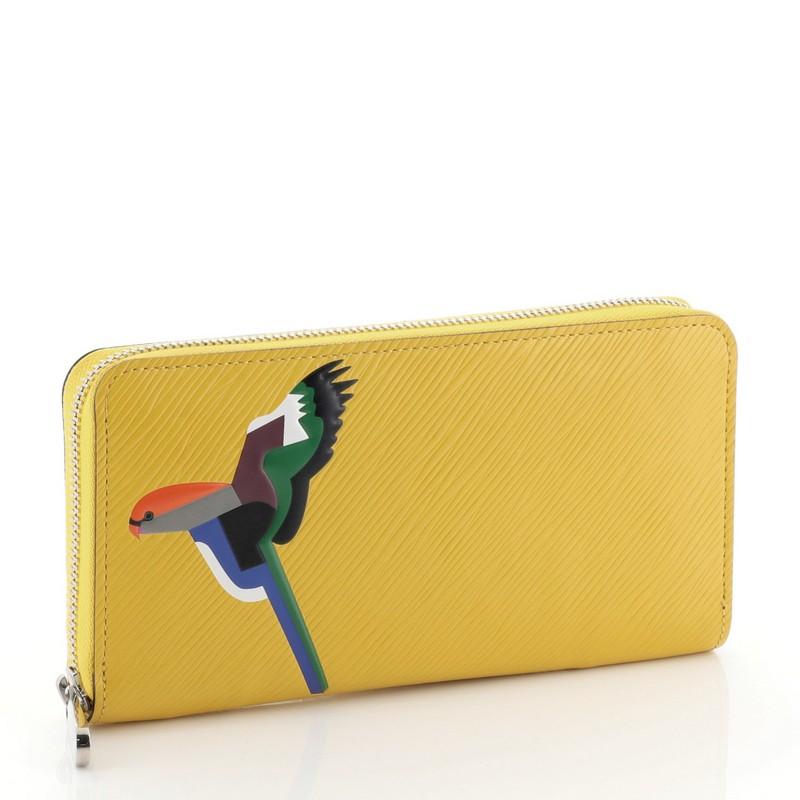 This Louis Vuitton Zippy Wallet Bird Motif Epi Leather, crafted from yellow epi leather, features a bird motif on both sides and silver-tone hardware. Its zip closure opens to a yellow leather interior with middle zip compartment, multiple card