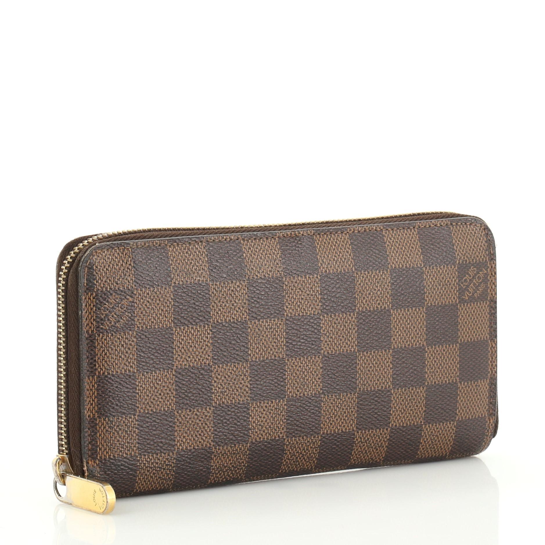 This Louis Vuitton Zippy Wallet Damier is an everyday piece with damier pattern introduced in 1888, from the French word which literally translates to Checker Board. Crafted from damier ebene coated canvas, it features gold-tone hardware. Its