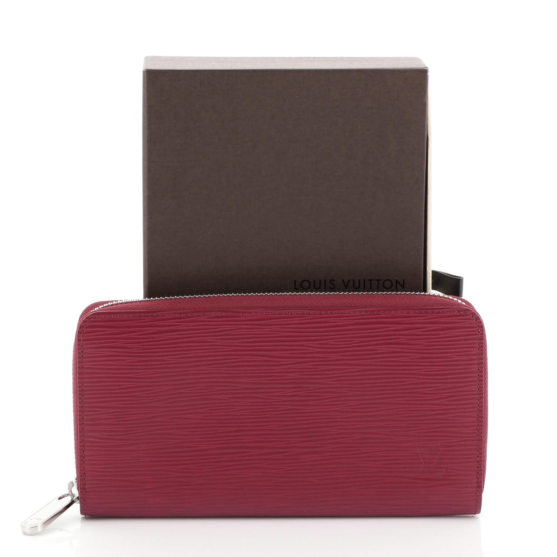 This Louis Vuitton Zippy Wallet Epi Leather, crafted in pink epi leather, features silver-tone hardware. Its zip around closure opens to a pink leather interior with multiple card slots, zip compartment and slip pocket. Authenticity code reads: