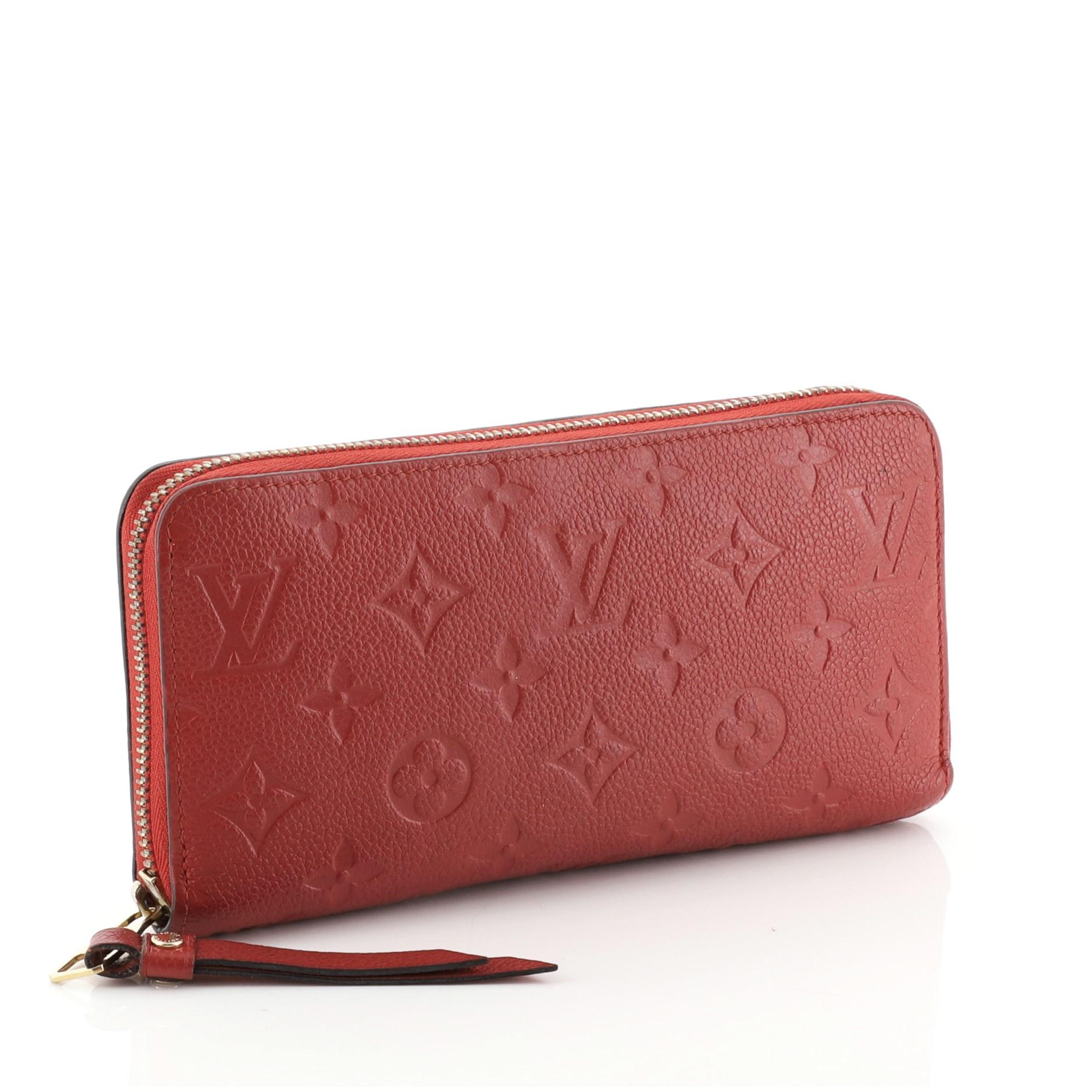 This Louis Vuitton Zippy Wallet Monogram Empreinte Leather, crafted in red monogram empreinte leather, features gold-tone hardware. Its all-around zip closure opens to a red leather interior with a middle zip compartment, slip pocket, and multiple
