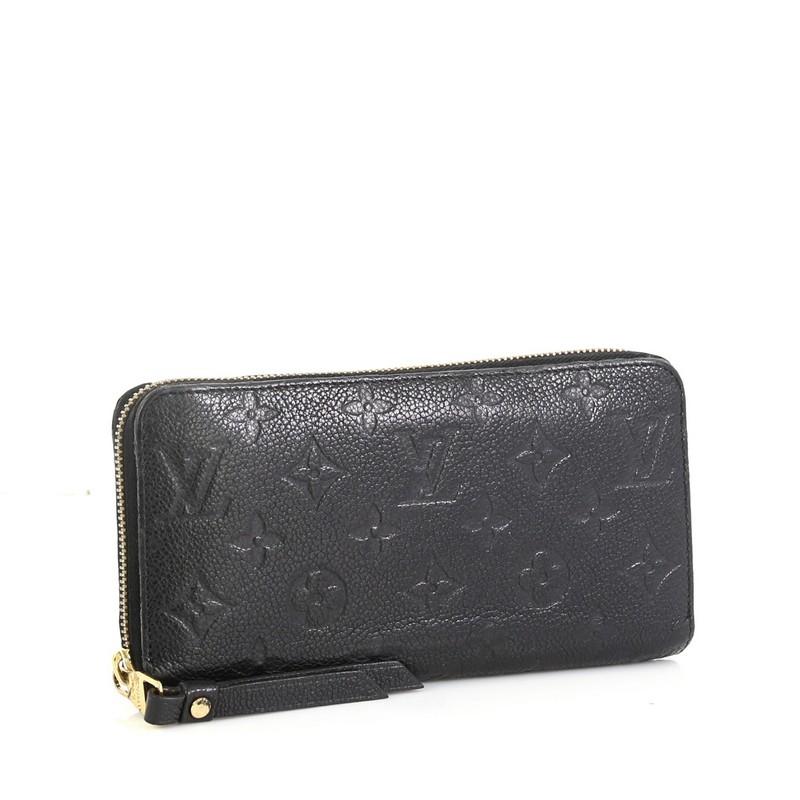 This Louis Vuitton Zippy Wallet Monogram Empreinte Leather, crafted in black monogram empreinte leather, features gold-tone hardware. Its zip closure opens to a black leather interior with multiple card slots, slip pockets and zip compartment.