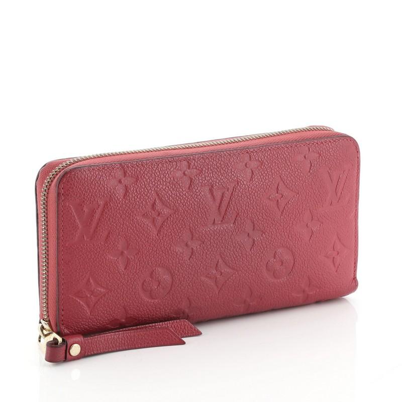 This Louis Vuitton Zippy Wallet Monogram Empreinte Leather, crafted in pink monogram empreinte leather, features gold-tone hardware. Its zip closure opens to a pink leather interior with multiple card slots, slip pockets and zip compartment.