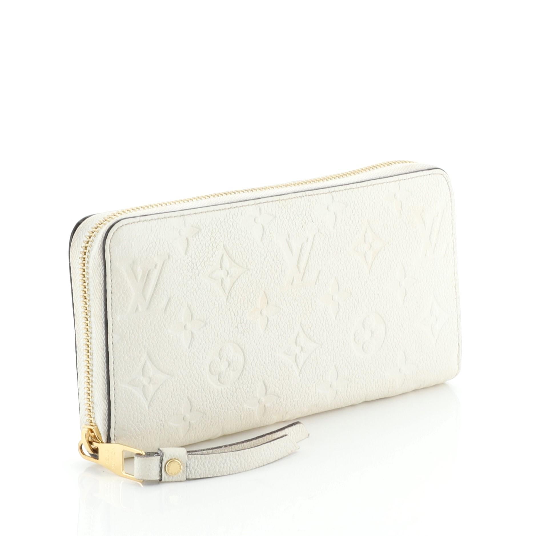 This Louis Vuitton Zippy Wallet Monogram Empreinte Leather, crafted in white monogram empreinte leather, features gold-tone hardware. Its all-around zip closure opens to a white leather interior with a middle zip compartment, slip pocket, and