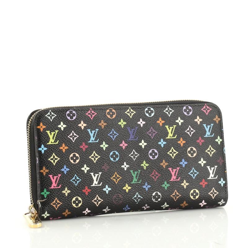 This Louis Vuitton Zippy Wallet Monogram Multicolor, crafted from black monogram multicolor coated canvas, features gold-tone hardware. Its all-around zip closure opens to a pink leather interior with multiple card slots, slip pocket, and zip
