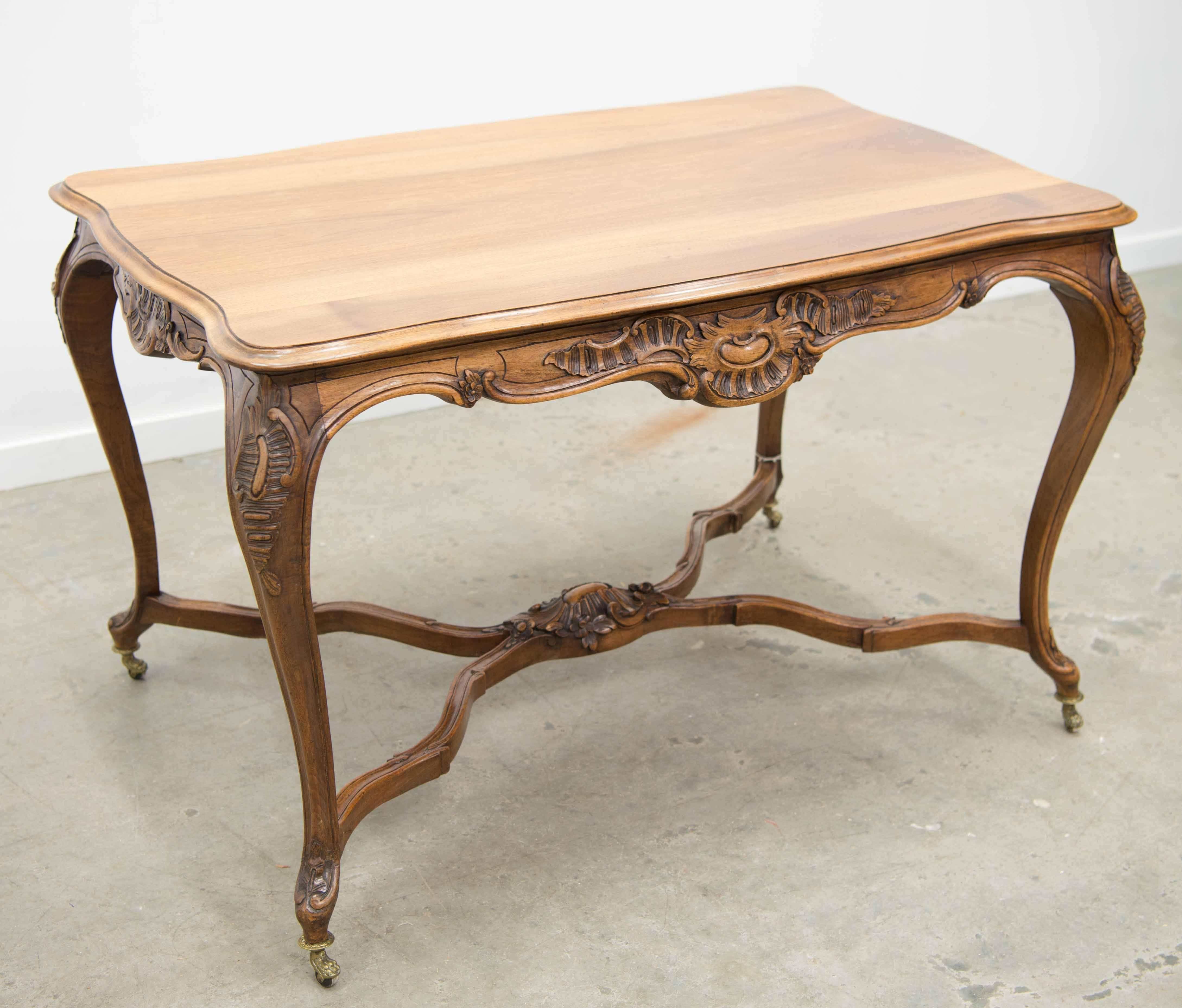 Large Louis XV style playing table on bronze feet with wheels.
The table has a warm hue and was most likely made circa 1920.
The table was most likely used as a side table or playing or game table, due to the size. 

Please note: This item is