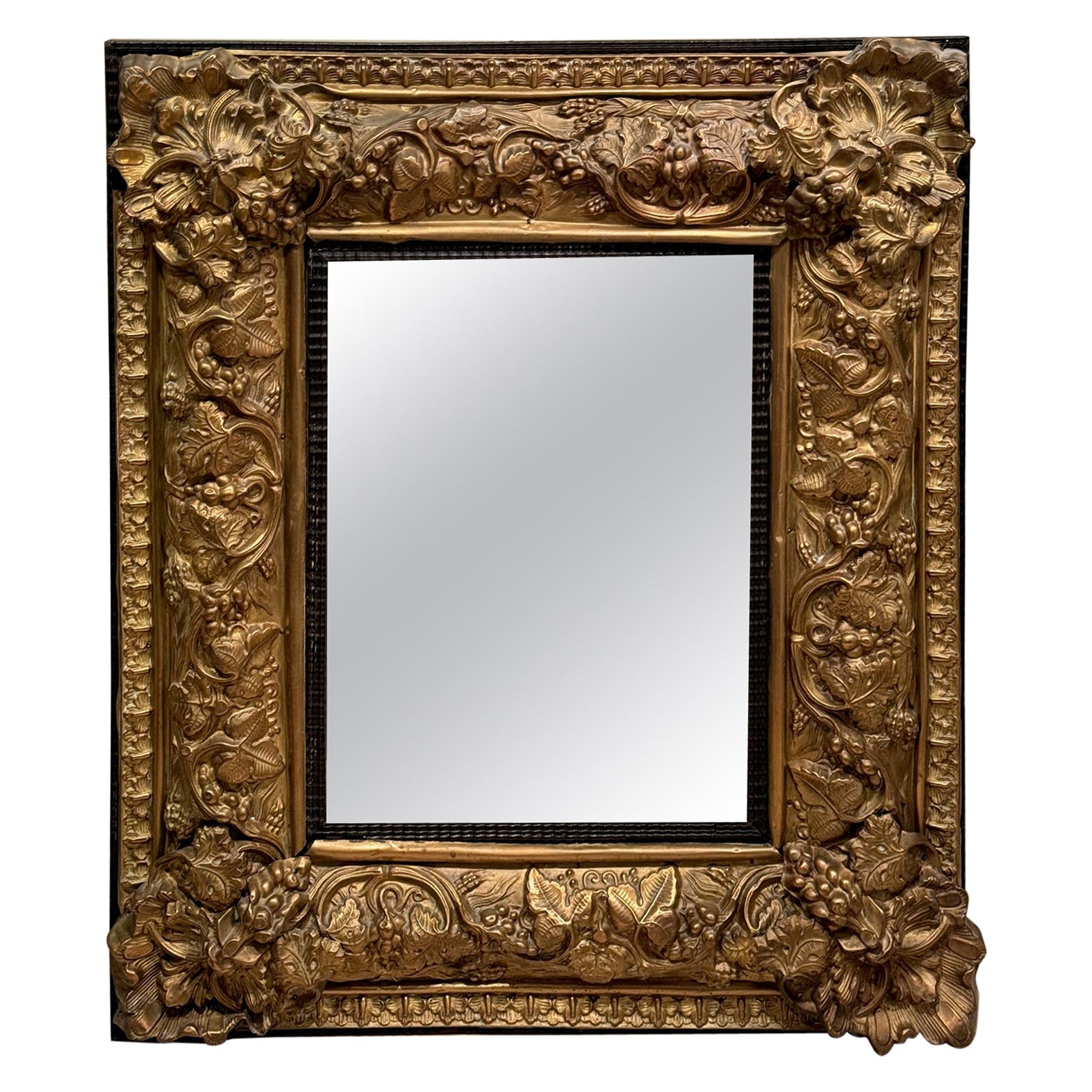 Louis XIII mirror in embossed copper, 19th C.