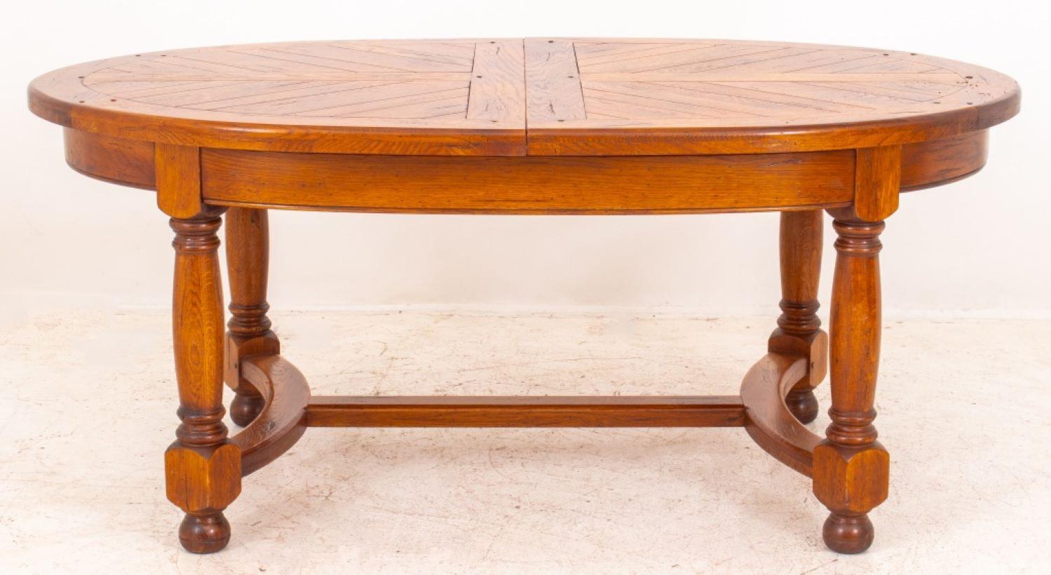 French Louis XIII style oak parquetry extending oval dining table raised on turned legs joined by stretchers, two leaves. Measures: Without extension: 30.5