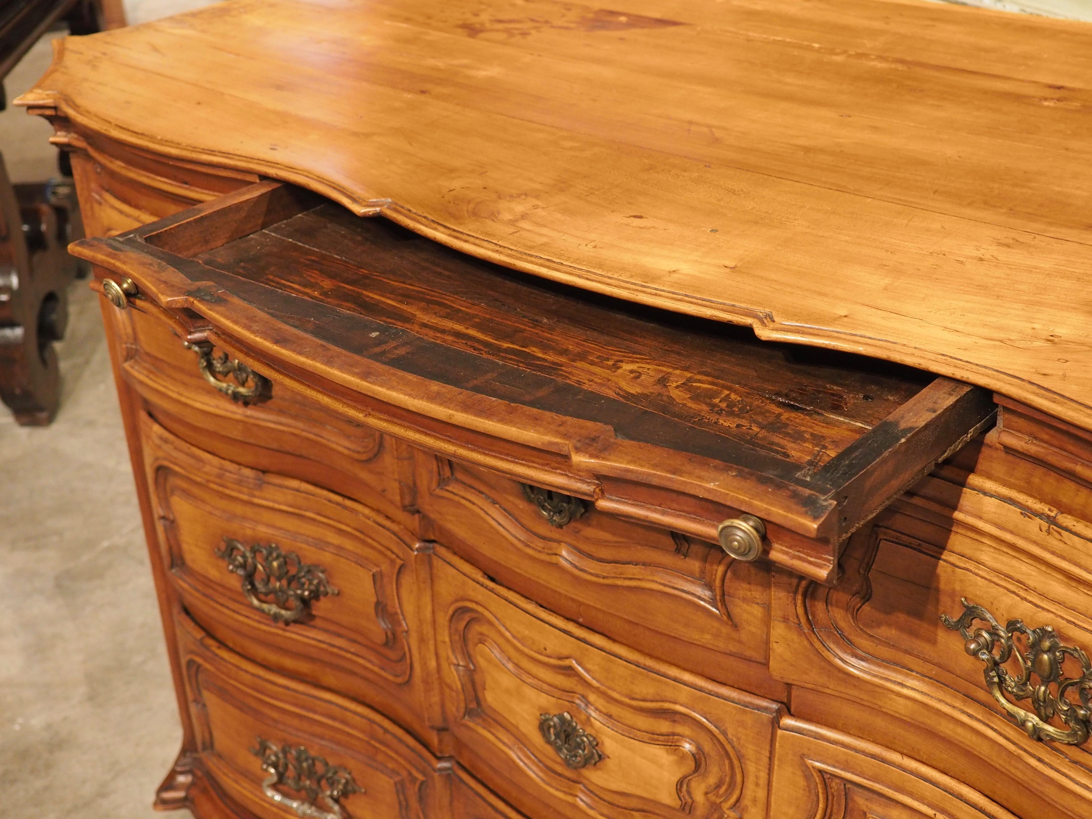 The straight grain and rich color of the cherry tree made it a desirable wood for constructing luxury furniture during the 18th century. One beautiful example is our period Louis XIV commode, which was hand-carved in France in the early