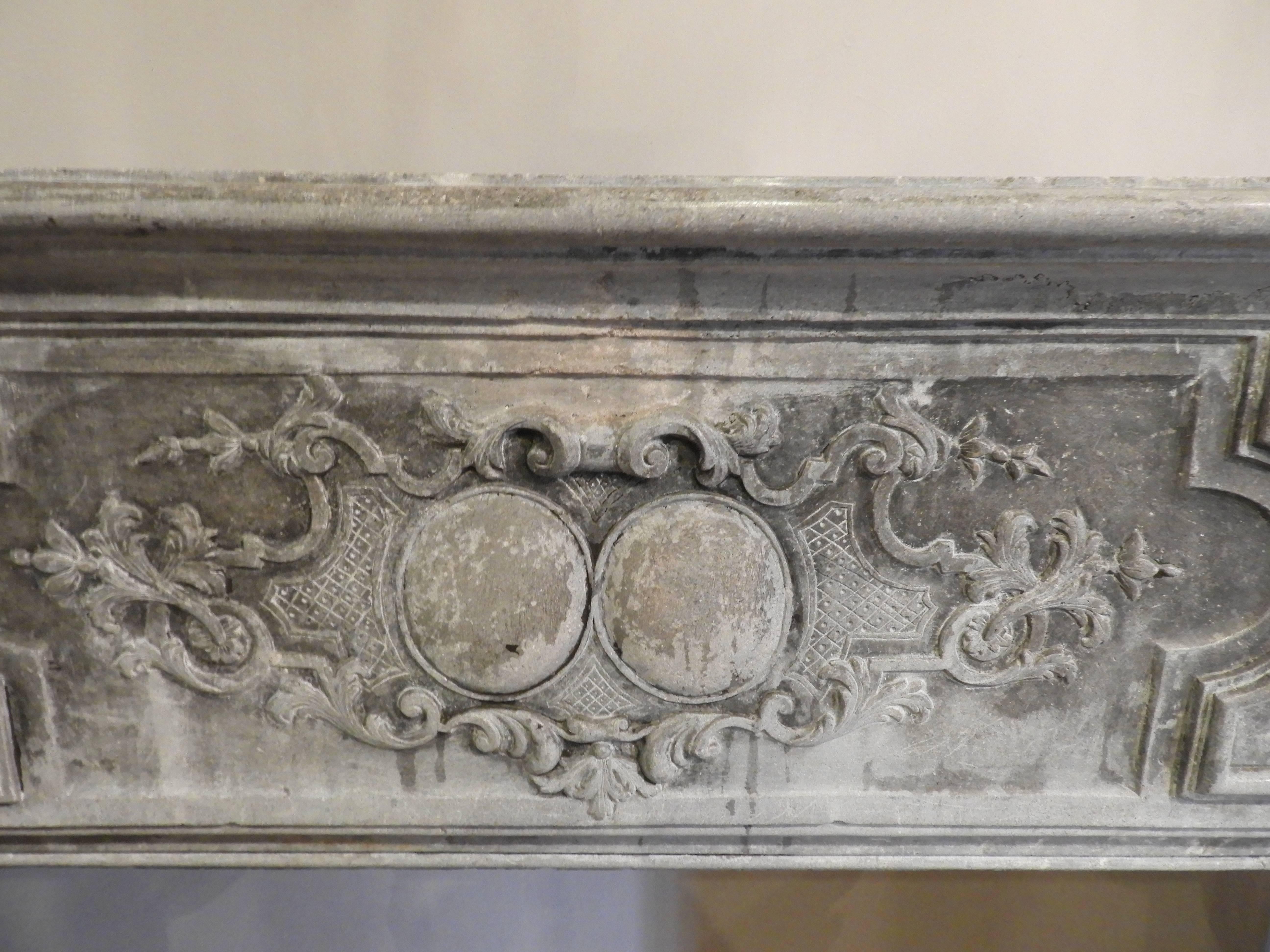 Louis XIV fireplace in grey limestone At Least 19th century, this very ornate fireplace come from the area of Besançon in France, just a few areas have this very popular grey color. There are minor restorations to be done and are included in the
