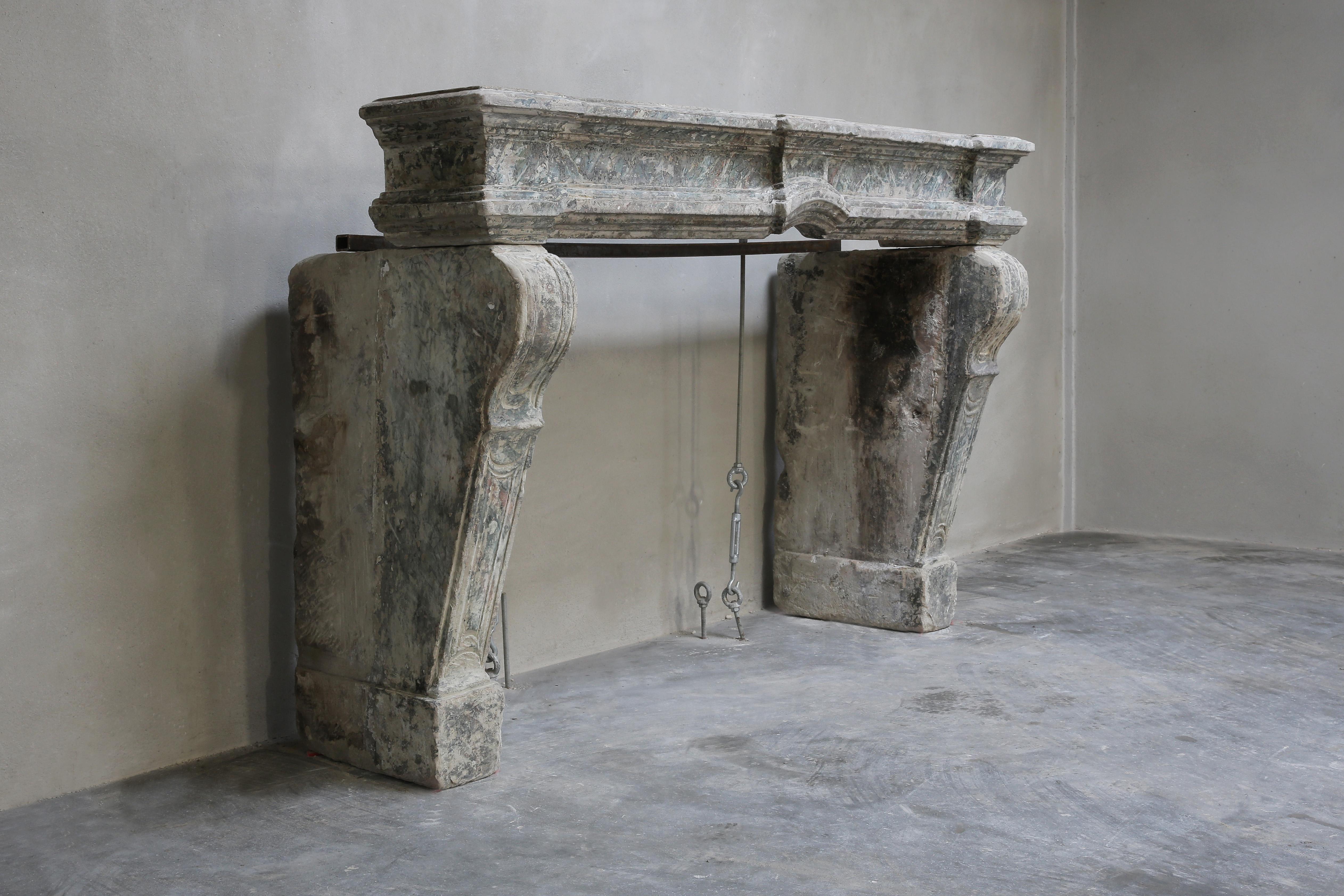 Special antique fireplace from the 19th century in the style of Louis XIV. This fireplace has a beautiful patina and distinct shapes. The legs are slightly curved and have beautiful lines. A very unique fireplace of which there is only one!