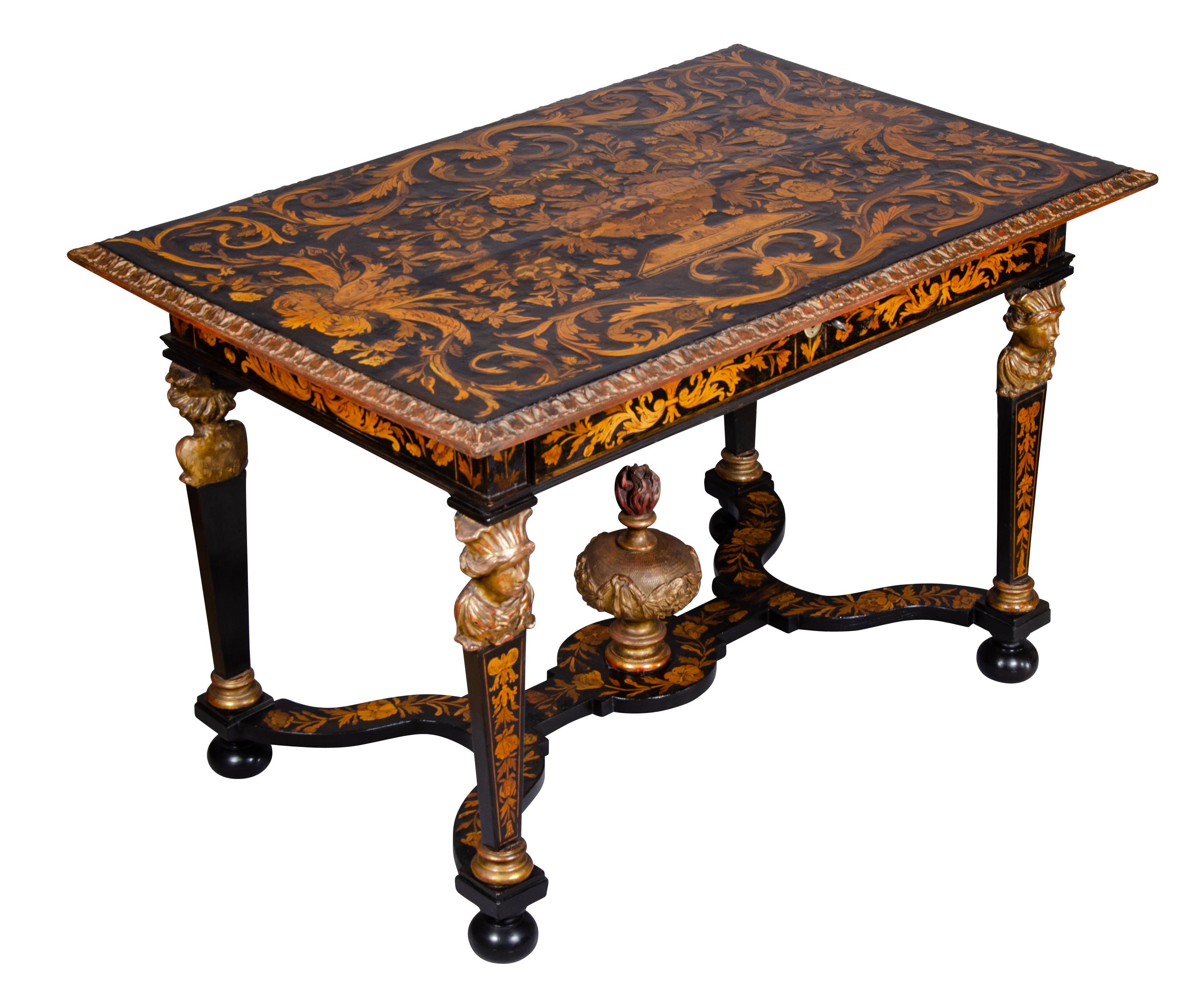 A very fine table with exquisite floral marquetry top with central urn of flowers surrounded by flowers and birds all within scrolling arabesques. Carved giltwood edge.Containing a frieze drawer and raised on gilded figural and ebonized square