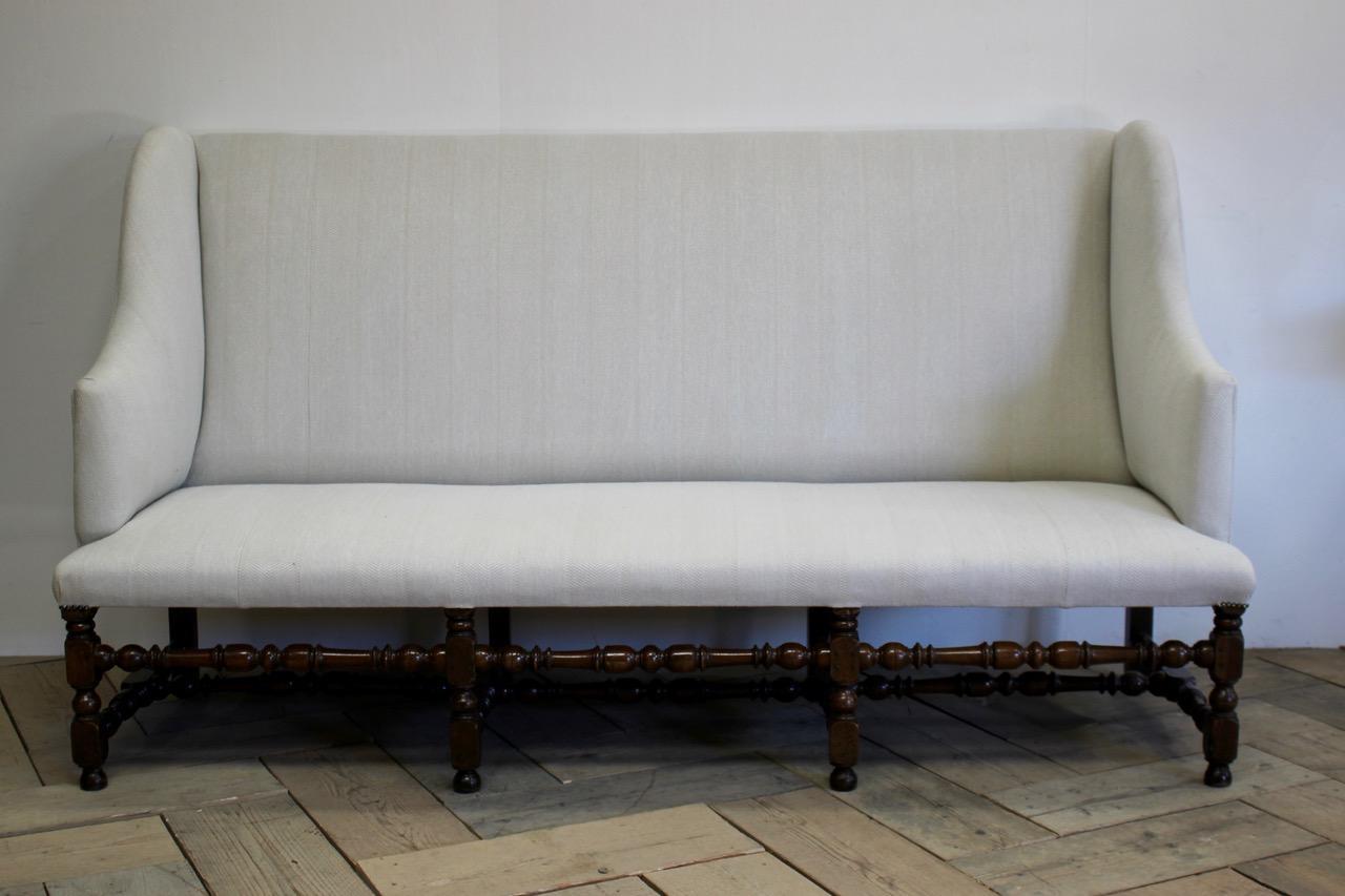 A large Louis XIV French eight-legged period sofa in walnut upholstered in a neutral fabric. 
Lovely color.