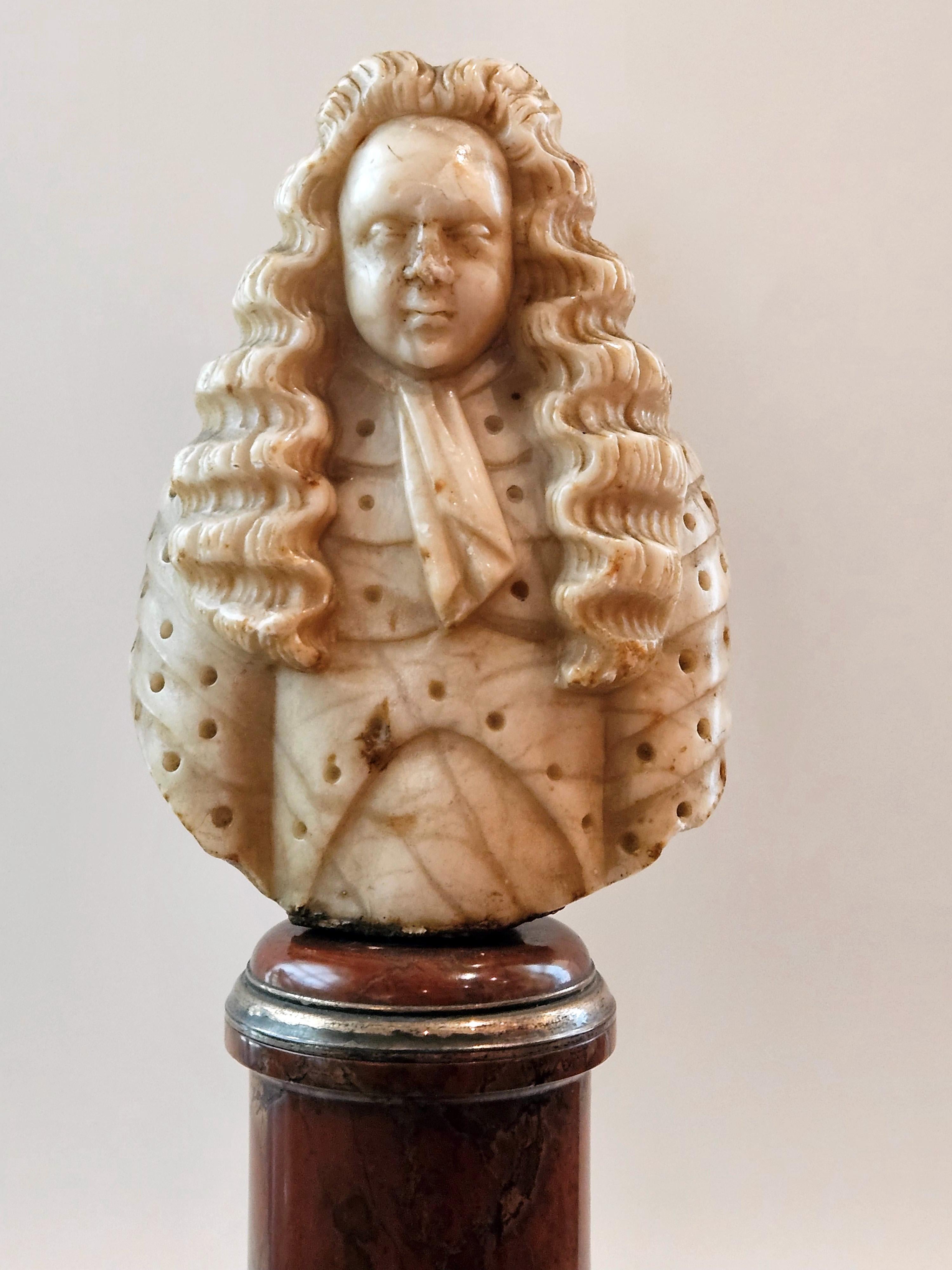 Louis XIV style bust of a man in armor.
France, Late 17th century 
Alabaster on a griotte red marble base
Base diameter 7 cm 
Bust width 8.5 cm