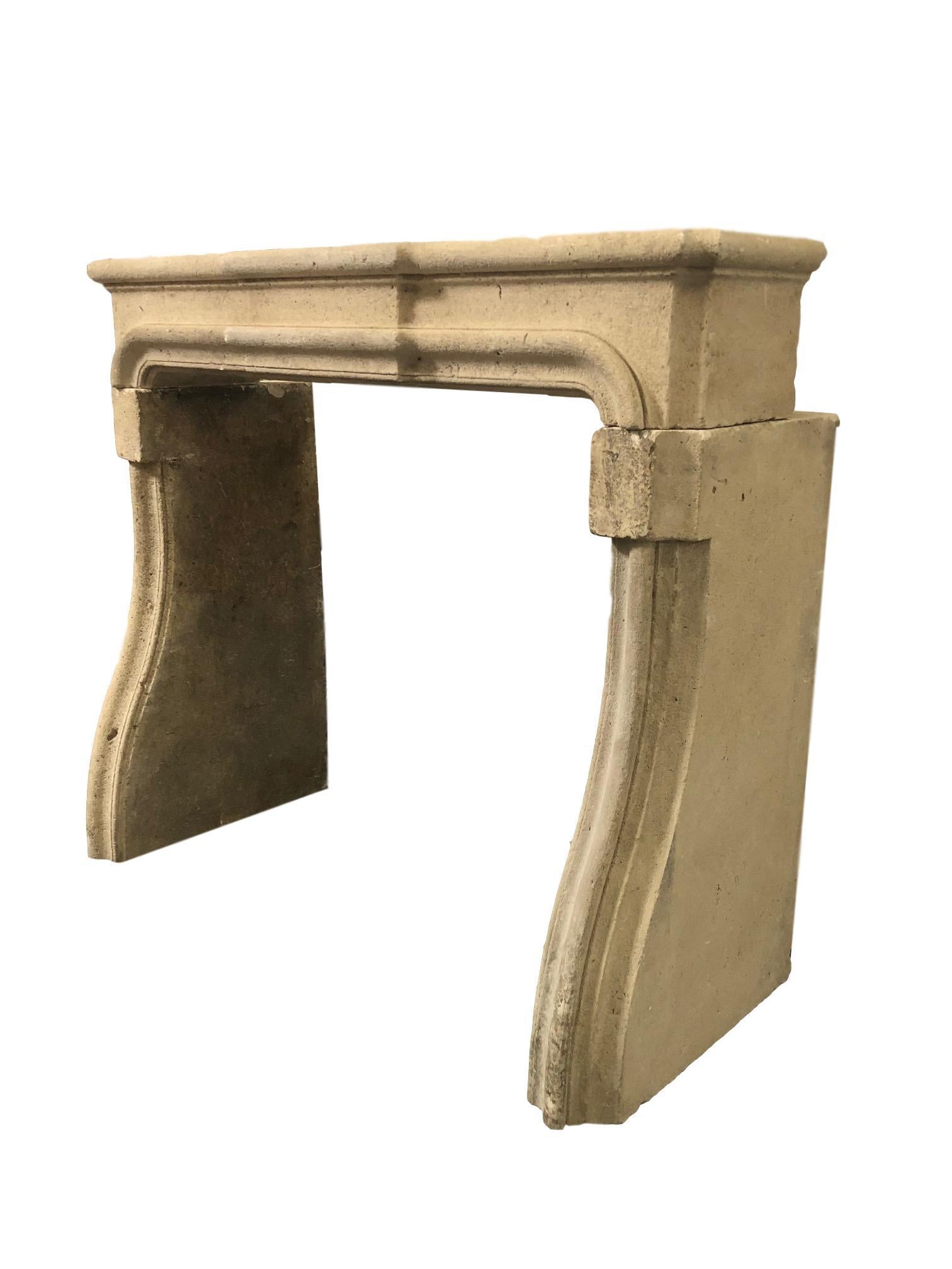 Louis XIV style carved limestone fireplace mantel created by hand and perfectly distressed to create great age. The natural lines and neutral tones allow this piece to work in a variety of spaces from living rooms, bedrooms, loggias and more.