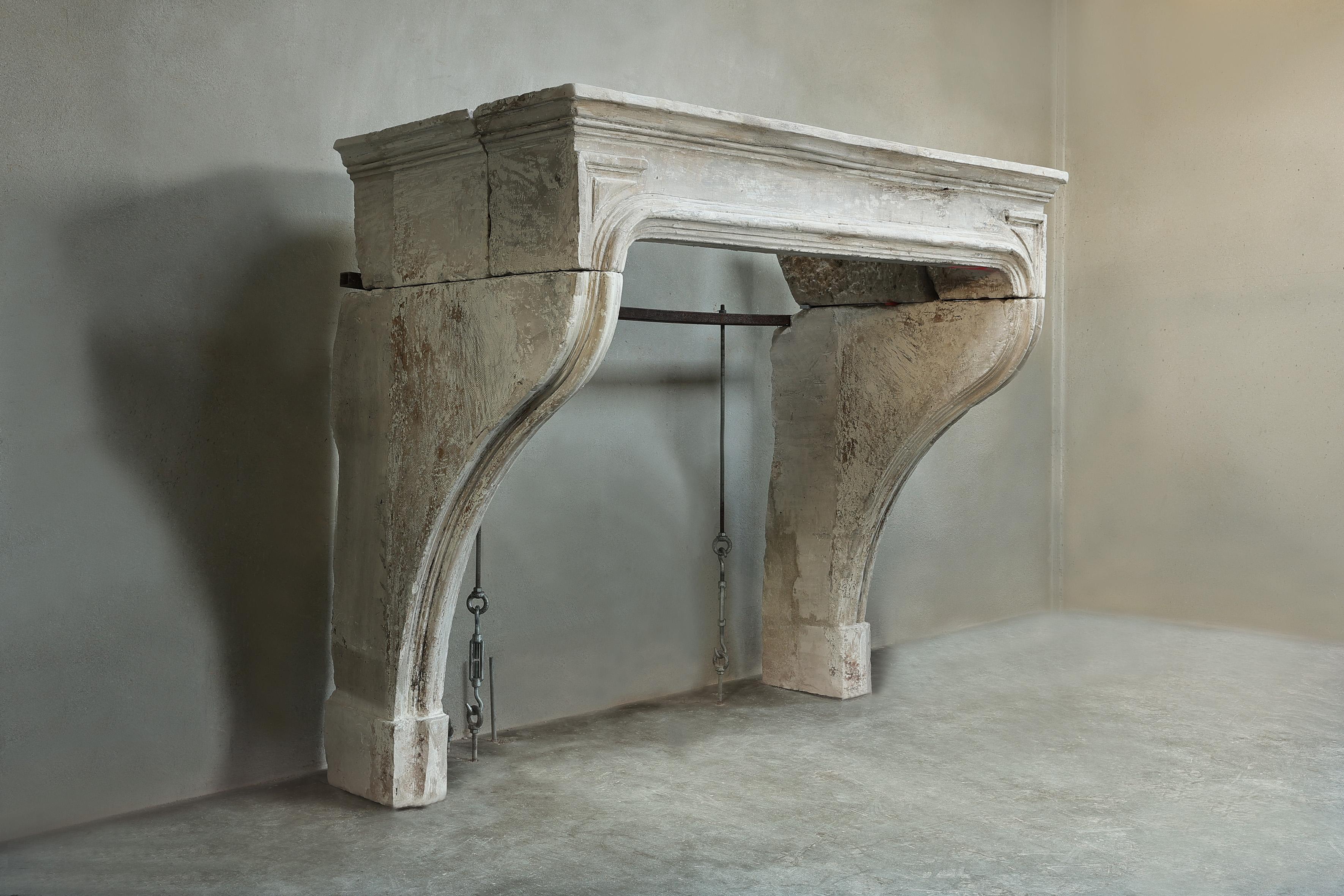 Beautiful rustic French limestone fireplace from the 19th century in the style of Louis XIV! This antique fireplace is characterized by its beautiful lines and stately appearance.