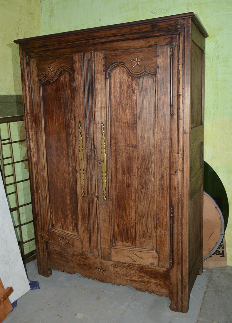 Handsome two-door antique French Louis XIV to XV transition period wardrobe armoire. Two recessed panel doors with metal inlay stars and diamond decoration. Spacious interior armoire with original hardware.
