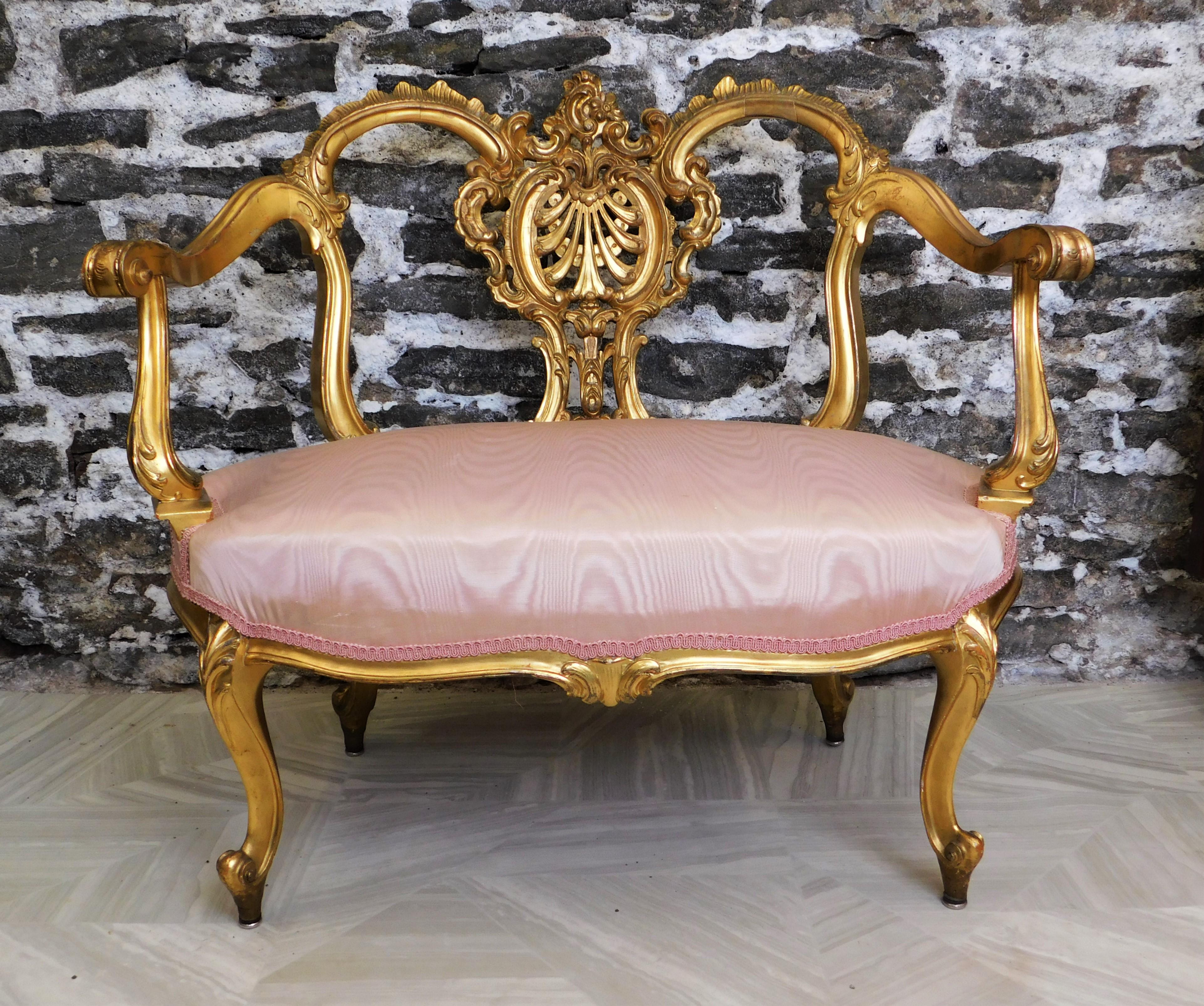 Nice hand carved Giltwood settee from the 1960's in the Louis the 14th style. Chair has been reupholstered. 36 inches wide by 32 inches high.