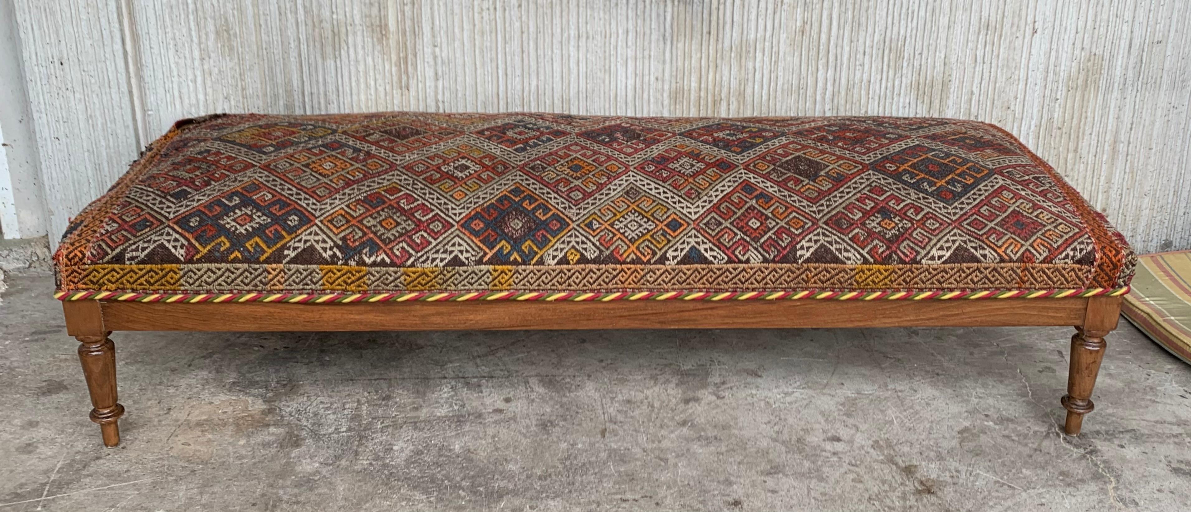 This beautiful Louis XIV style French bench was made in solid patinated oak in the early 1920s. Fully restored and newly upholstered with a large wool colorful geometric, this large bench will be a perfect addition to the foot of your bed, to your