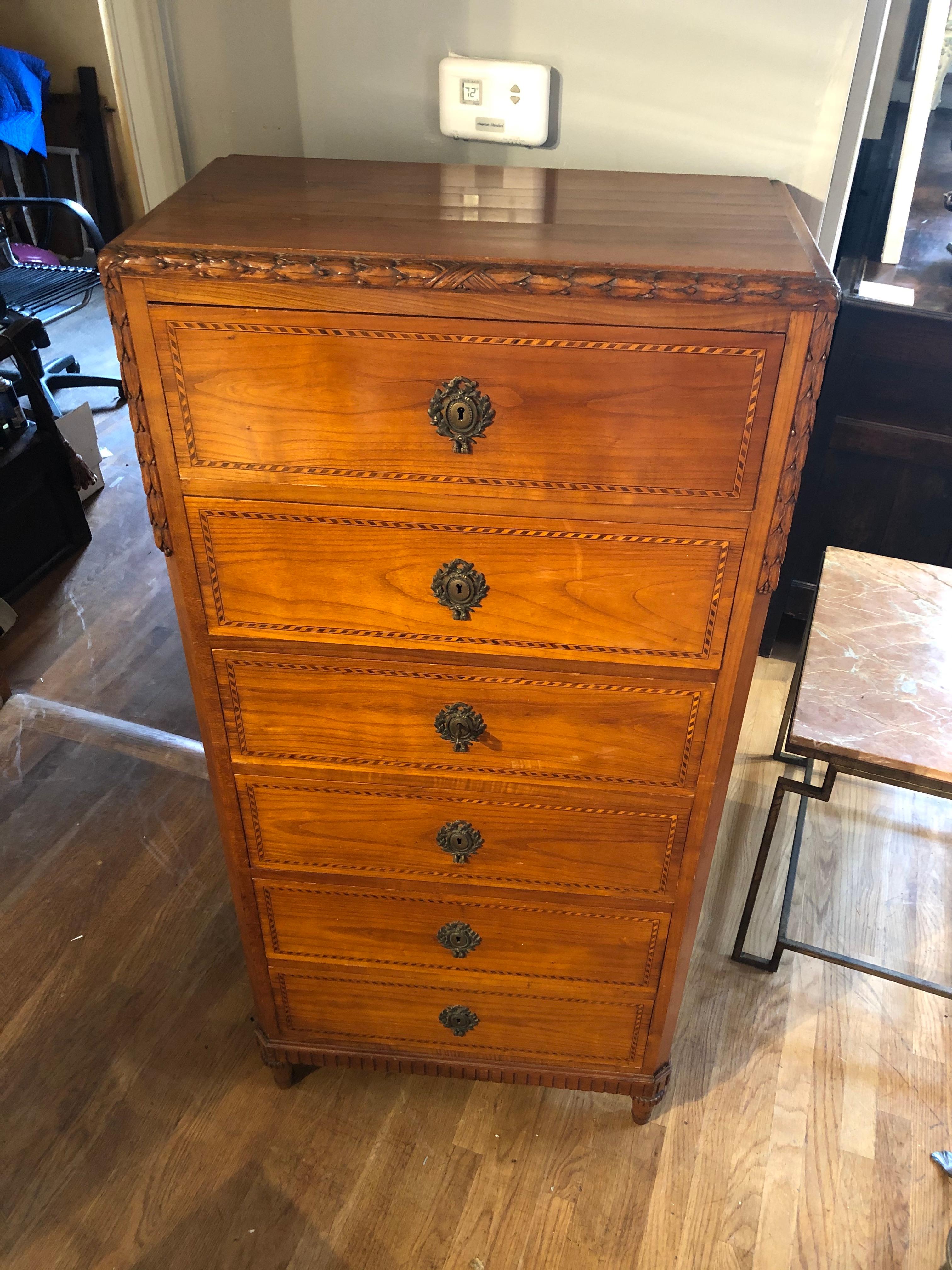 Louis XIV style French Provincial lingerie chest made of beautifully patinated pear wood with boxwood and king wood inlaid geometric decoration. Excellent proportions with six drawers that open by key with carved leaf decoration and the original