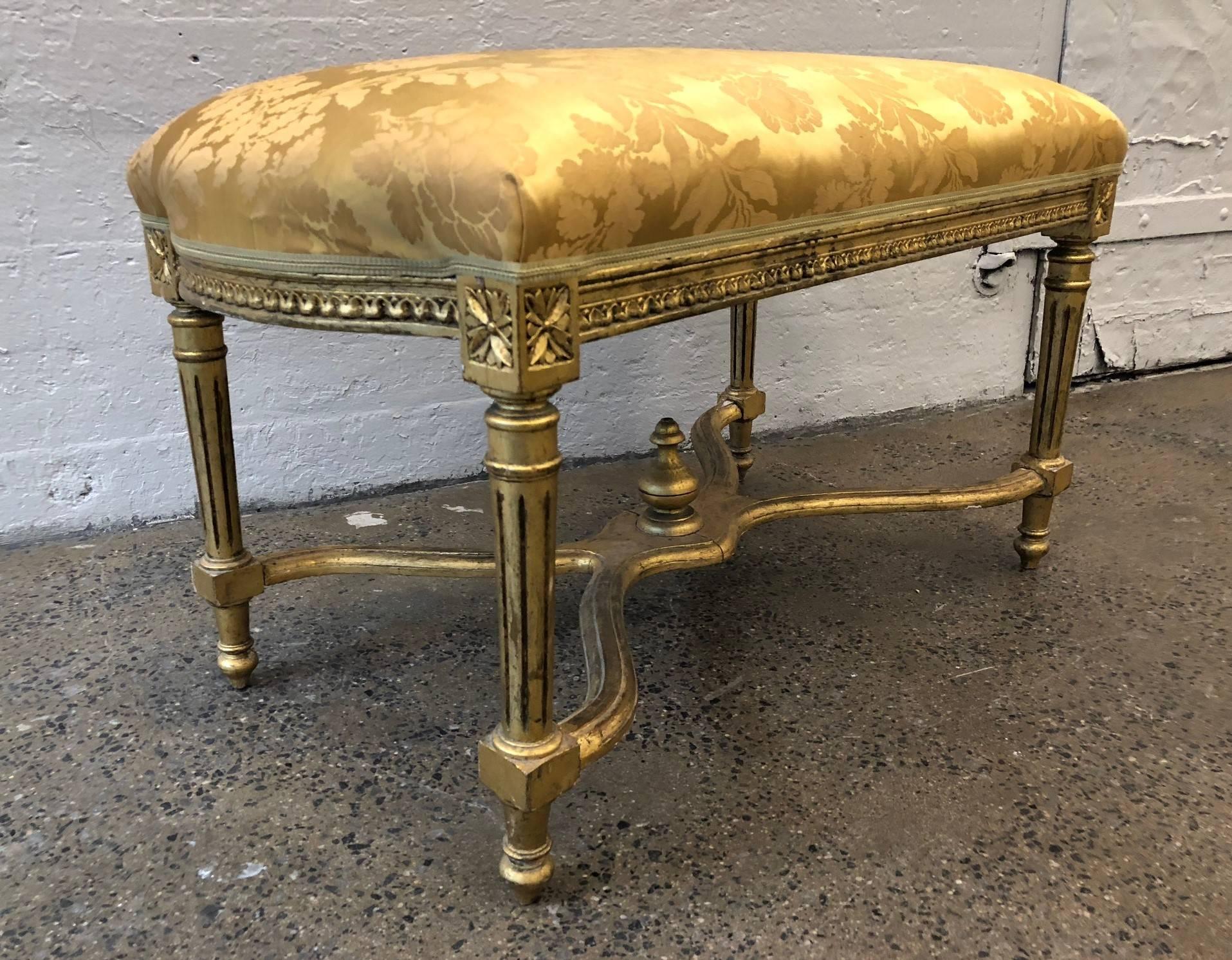 Louis XIV style giltwood bench. Upholstered in vintage gold silk fabric.