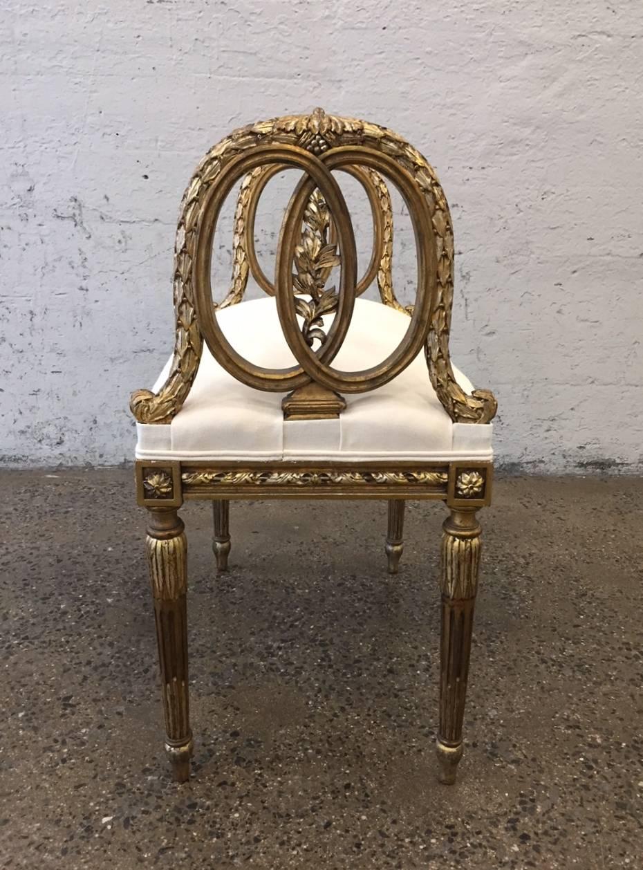 Louis XIV style giltwood bench with newly upholstered seat.