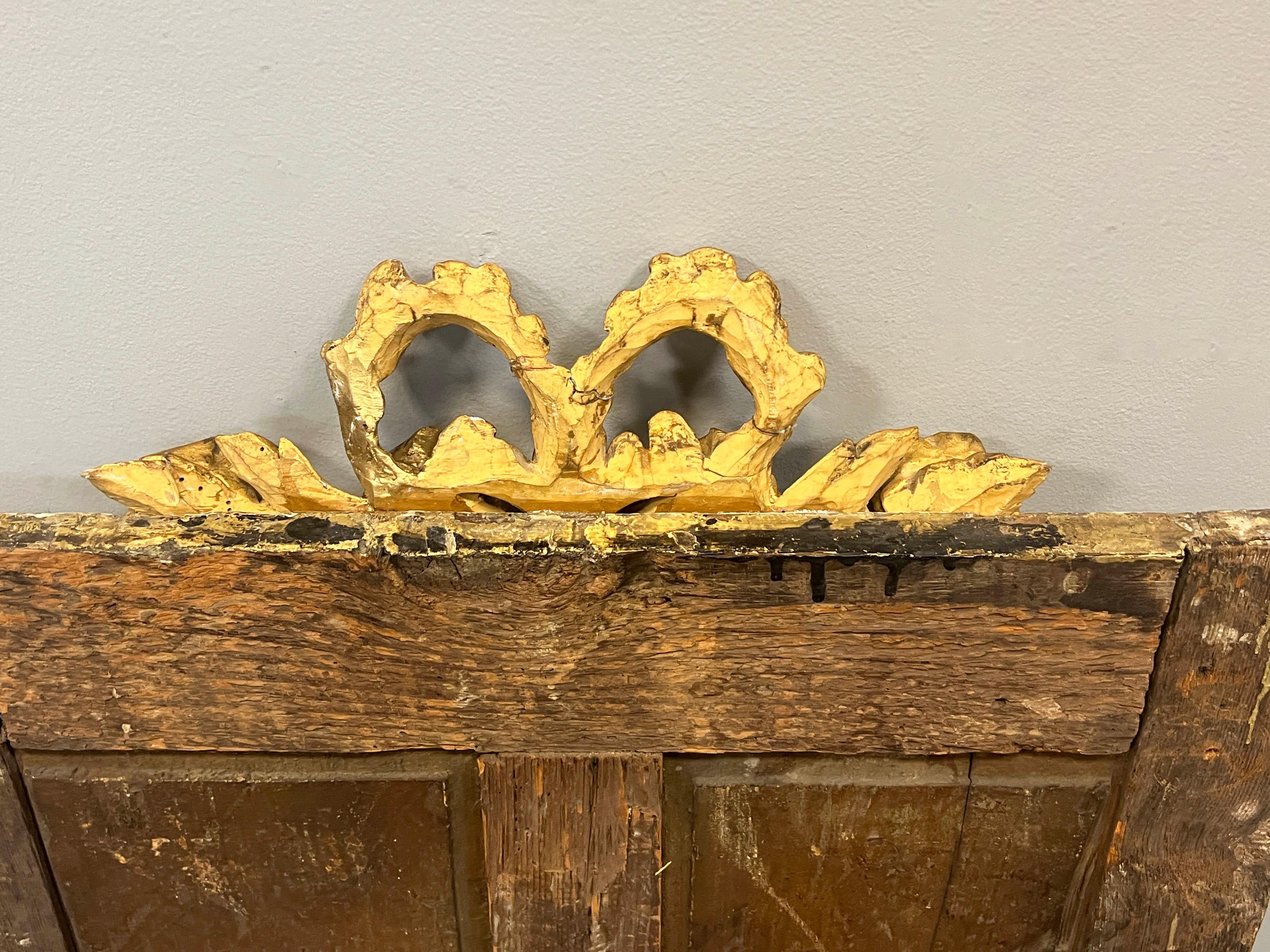 Custom made decorative Louis XVI style mirror composed of 20th century pieces. Gold gilt moulding with beading applied to old painted boiserie to form a mirror. Decorative hand carved gold leaf fragment applied to appear as a cartouche above the