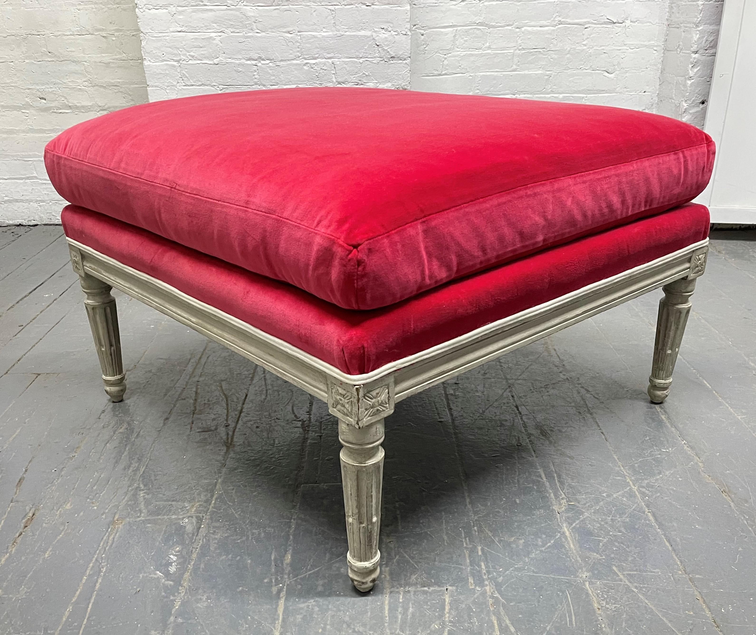 Louis XIV style ottoman. The ottoman has original fuchsia velvet upholstery with a painted wood frame.