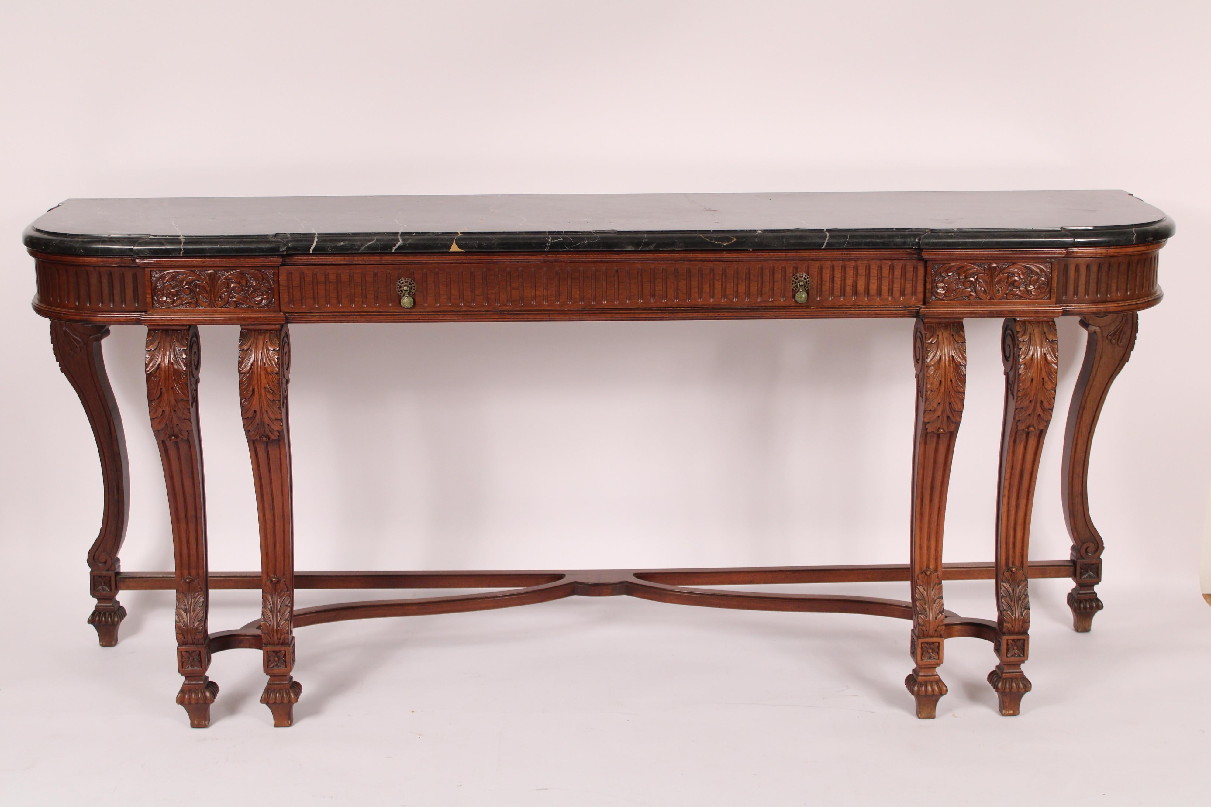 Louis XIV style walnut console table, circa 1930s. With a Belgium marble top, one wide frieze drawer and acanthus leaf Louis XIV style carved walnut legs. Hairline crack on marble top.