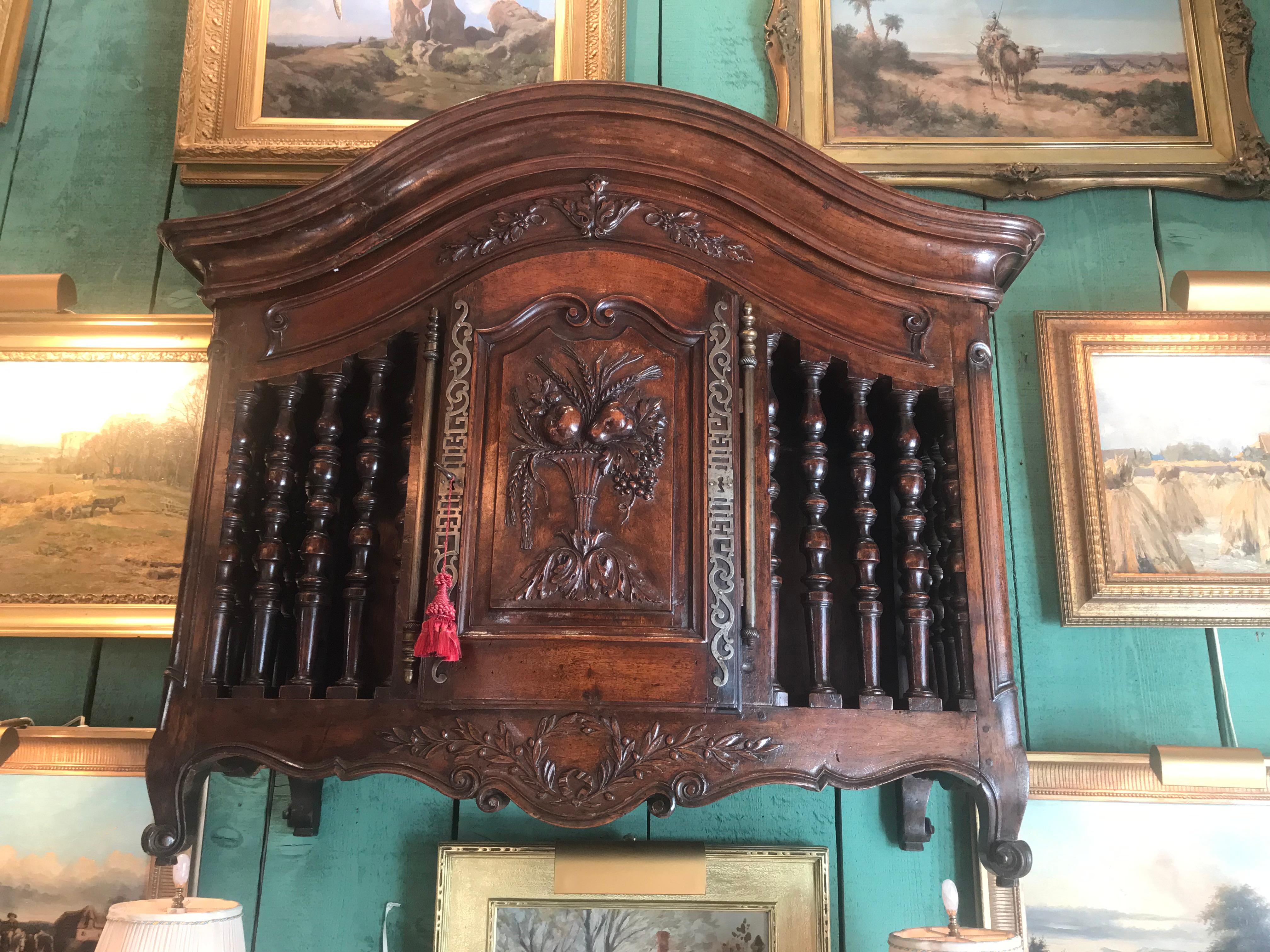 18th century exquisite Louis XV panetiere
Originally used to store French baguettes or long loaves of bread, panetieres were meant to sit on a petrin (dough chest) but eventually grew into elaborate decorative pieces which hung on the wall. This
