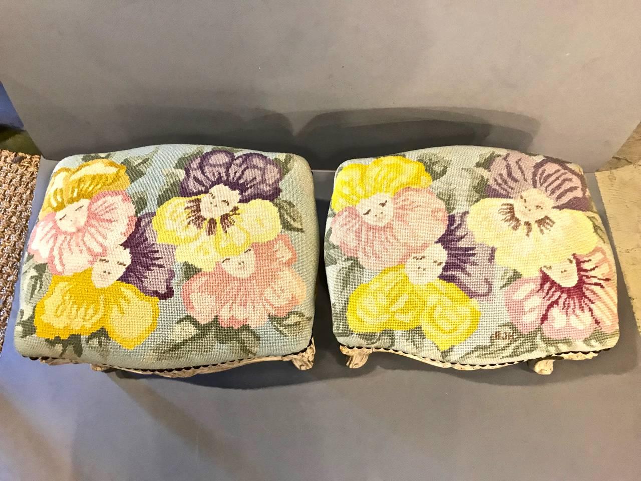 This is a unique associated pair of 18th and 19th century footstools that have been upholstered in a super chic and signed 1960s needlepoint. These stools are in the iconic Sister Parish style. One stool dates to the 18th century; its associated