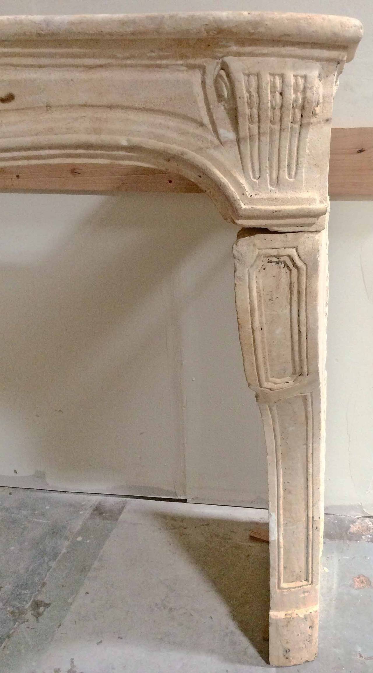 Louis XV antique limestone mantel. Featuring beautiful carvings along the frieze, as well as details on the handsome corbel legs.

Origin: France, circa 1680.

Measurements:
57 1/2? W x 32? D x 47? H.
Firebox: 48? W x 39 1/2? H.