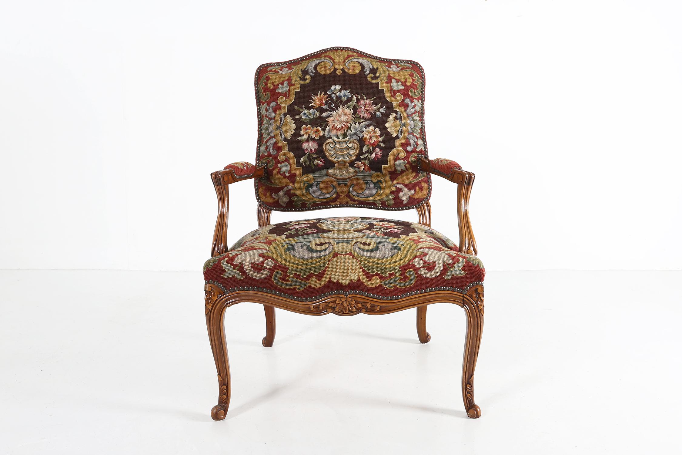 Louis XV armchair made in France.
made of a solid wooden base with some great sculpture details in the wood and a nice fabric with a flower pattern.