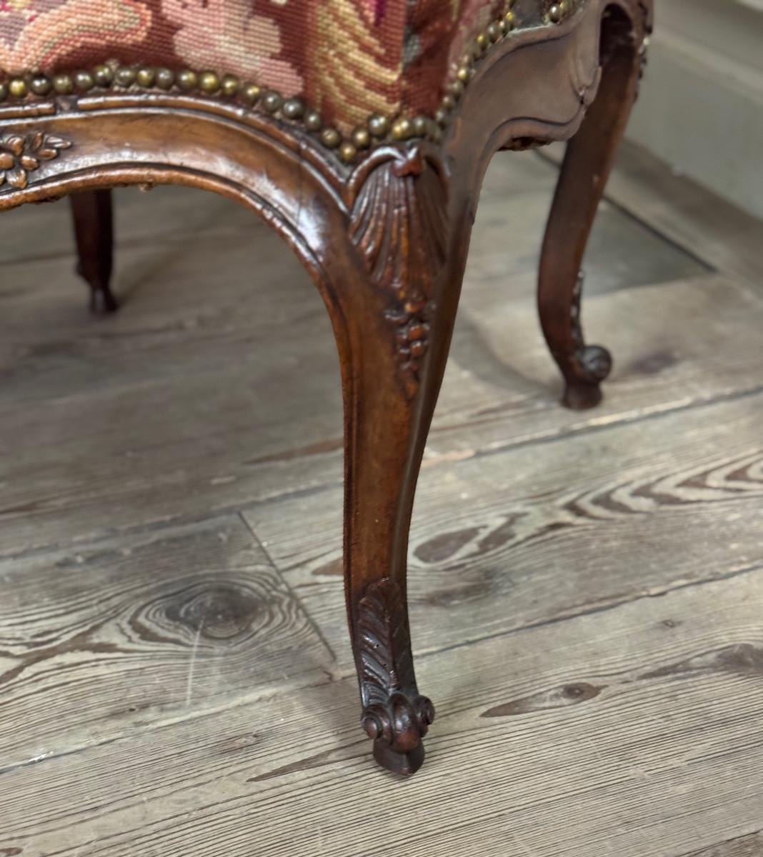 Louis XVI Louis XV armchair in carved walnut, petit point tapestry, 18th century For Sale