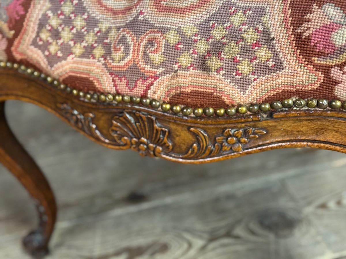 19th Century Louis XV armchair in carved walnut, petit point tapestry, 18th century For Sale