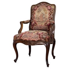 Louis XV armchair in carved walnut, petit point tapestry, 18th century