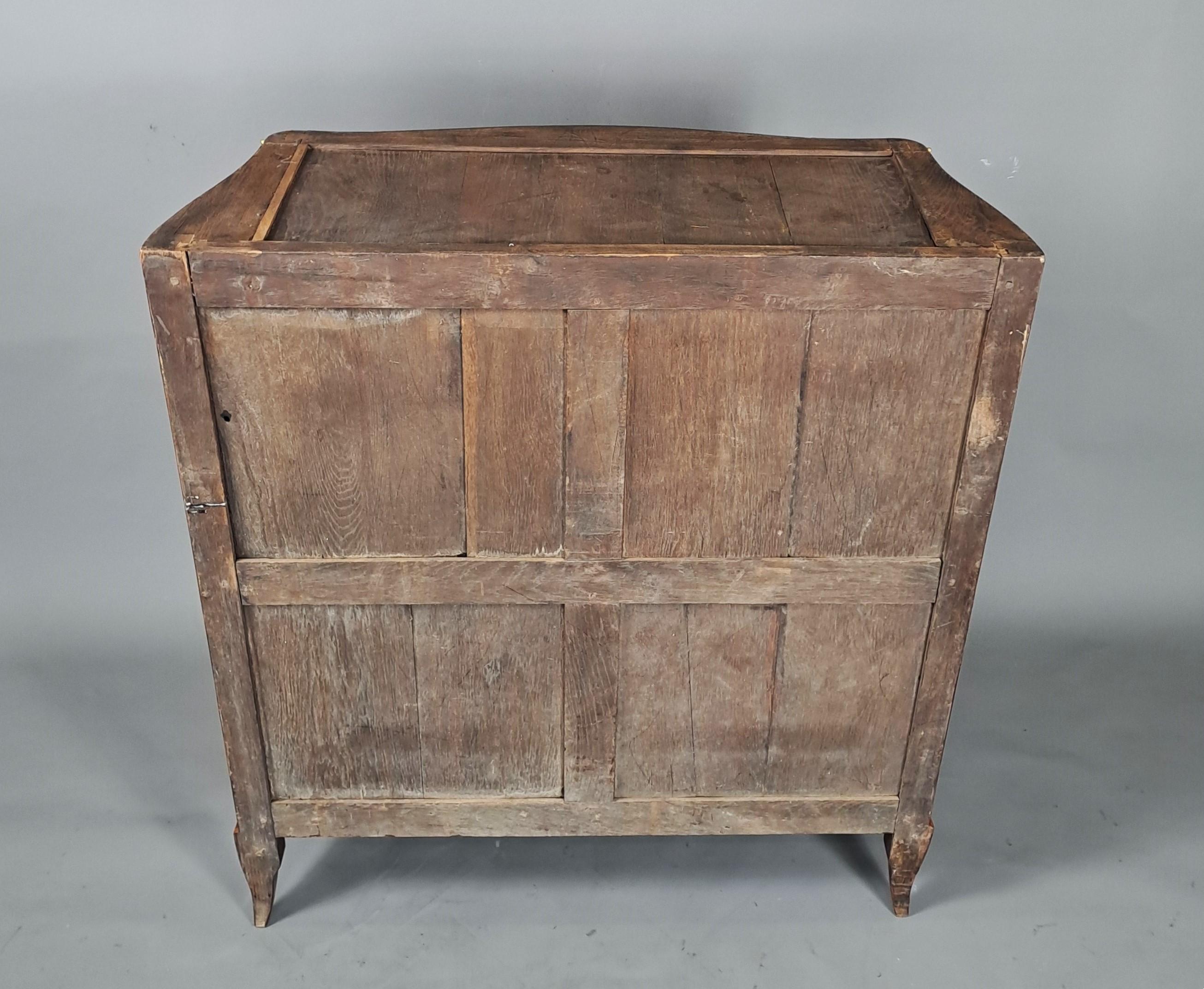 Rare Louis XV armoirette at support height, curved on all sides, presenting a rich floral marquetry decoration made of rosewood and rosewood veneer.   

Ornate gilt and chiseled bronze.   

Beautiful breccia marble top in sand and gold tones.  
