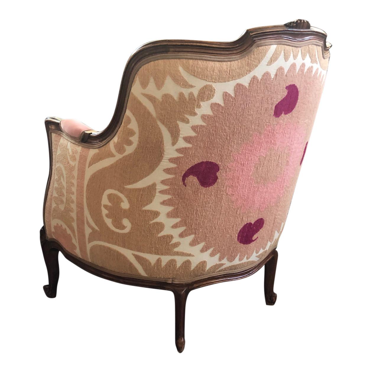 This is a so called Louis XV Bergère style chair from the 20th century. The chair is made from beech wood and has cabriole legs. The front has been upholstered with a new fabric from Designers Guild in a light pink peachy colour. The back of the