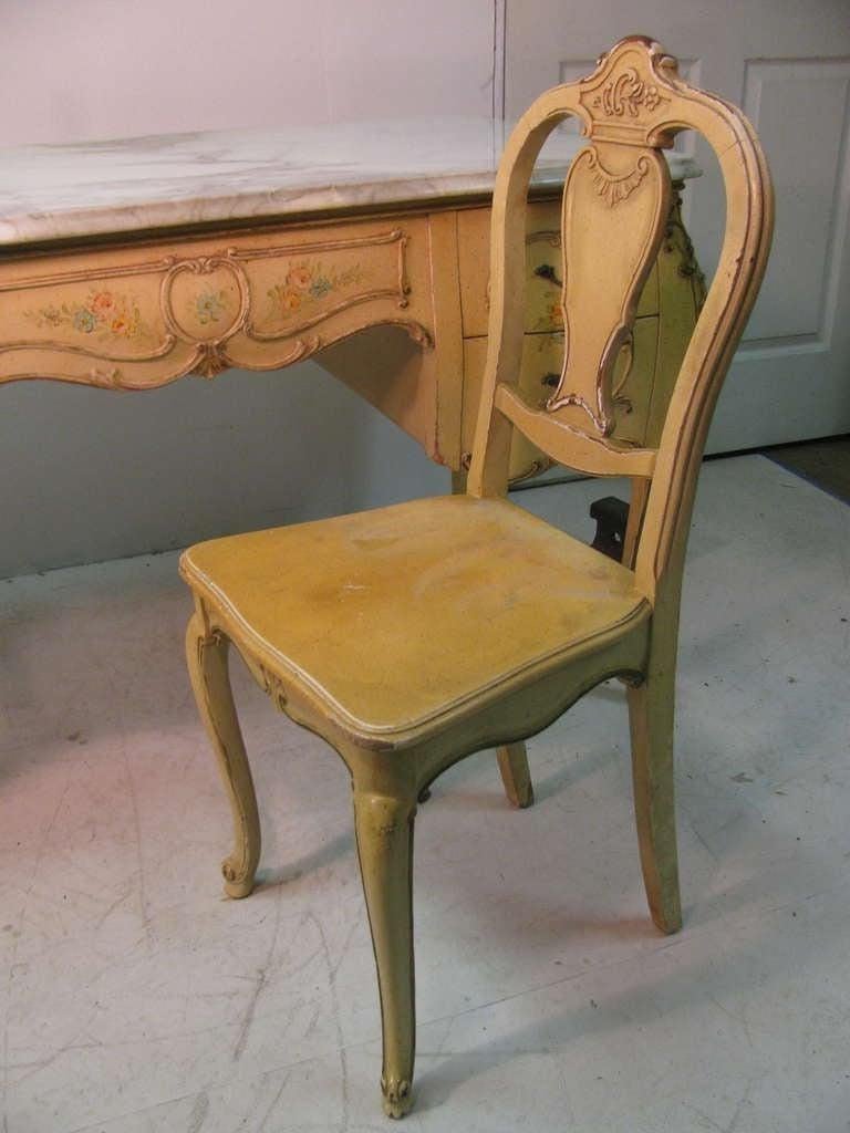 Beautiful five-drawer desk with hand carvings (see thumbnail photos) and paint decorated in the Louis XV style. Top quality workmanship in every phase. Original matching chair with this desk that is finished on all sides and can be placed in the