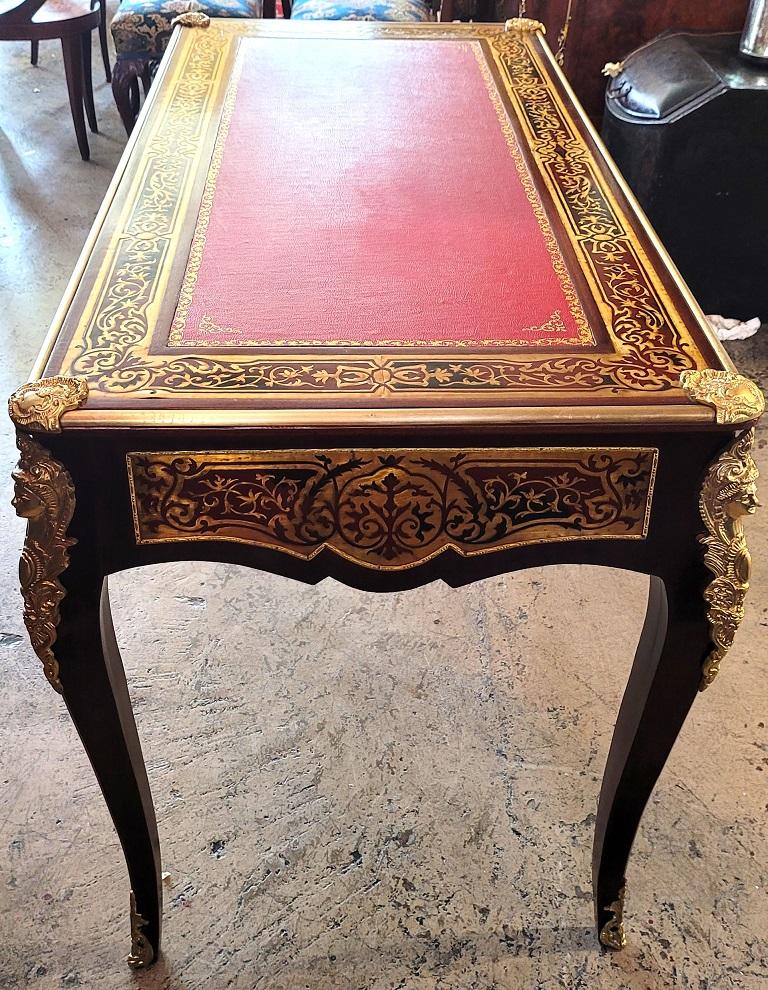 Presenting a lovely Louis XV Boulle style Bureau de Plat.

This is a desk or Bureau de Plat in the classic Boulle and Louis XV Styles.

Not an antique and probable made circa 2000 in Italy.

The ormolu mounts are of very good quality and