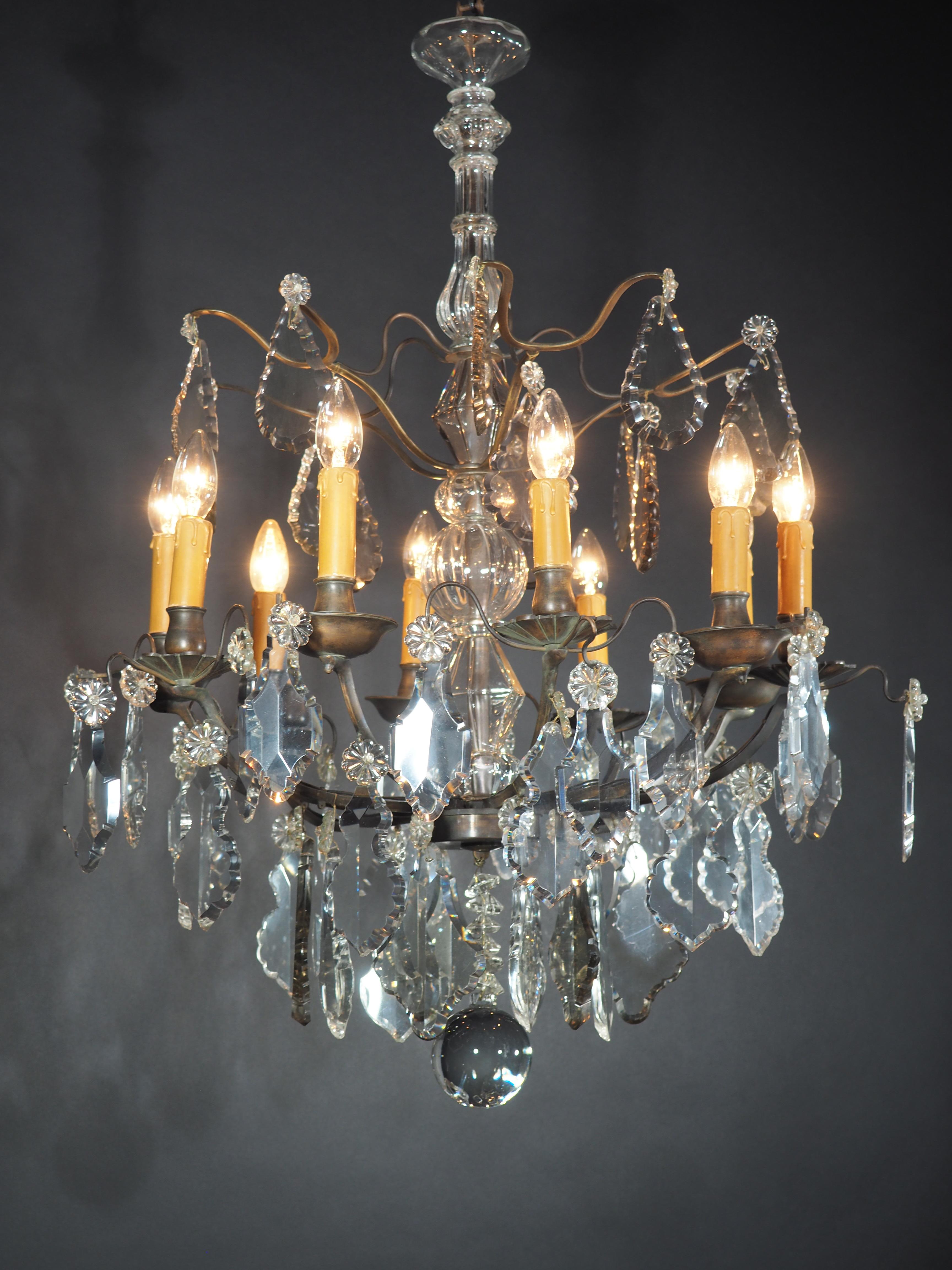 A wonderful Louis XV ten-light  crystal chandelier attributed to Baccarat, France, circa 1880s.
This beautiful chandelier is made of dark bronze suspended with big crystal prism in three different colors ( amethyst, smoke and clear) and has been