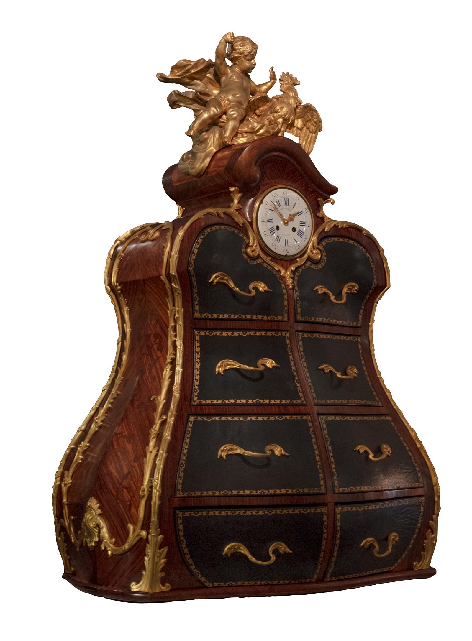 A highly unusual Louis XV gilt-bronze mounted marquetry cartonnier. France, 18th century. This bombé shaped cartonnier (an ornamental box for papers usually for placing on a desk), surmounted by a gilt-bronze putto and a cockerel. The top section is