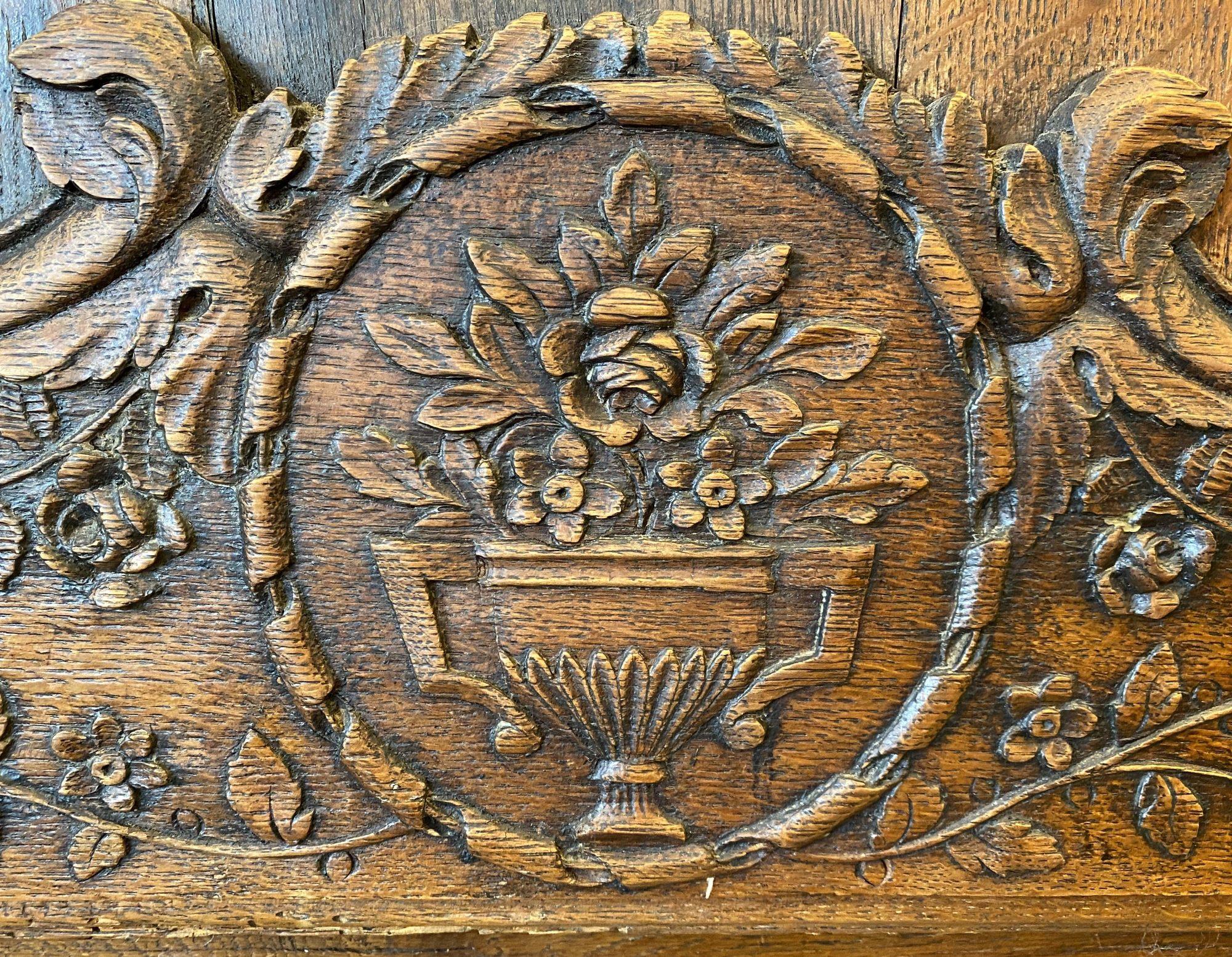 Louis XV carved homme debout cabinet or bonnetier with drawers, late 18th century, one-part form, relief carved pediment with central flower basket and vine, single relief carved and paneled hinged door, shelved interior, over three relief carved