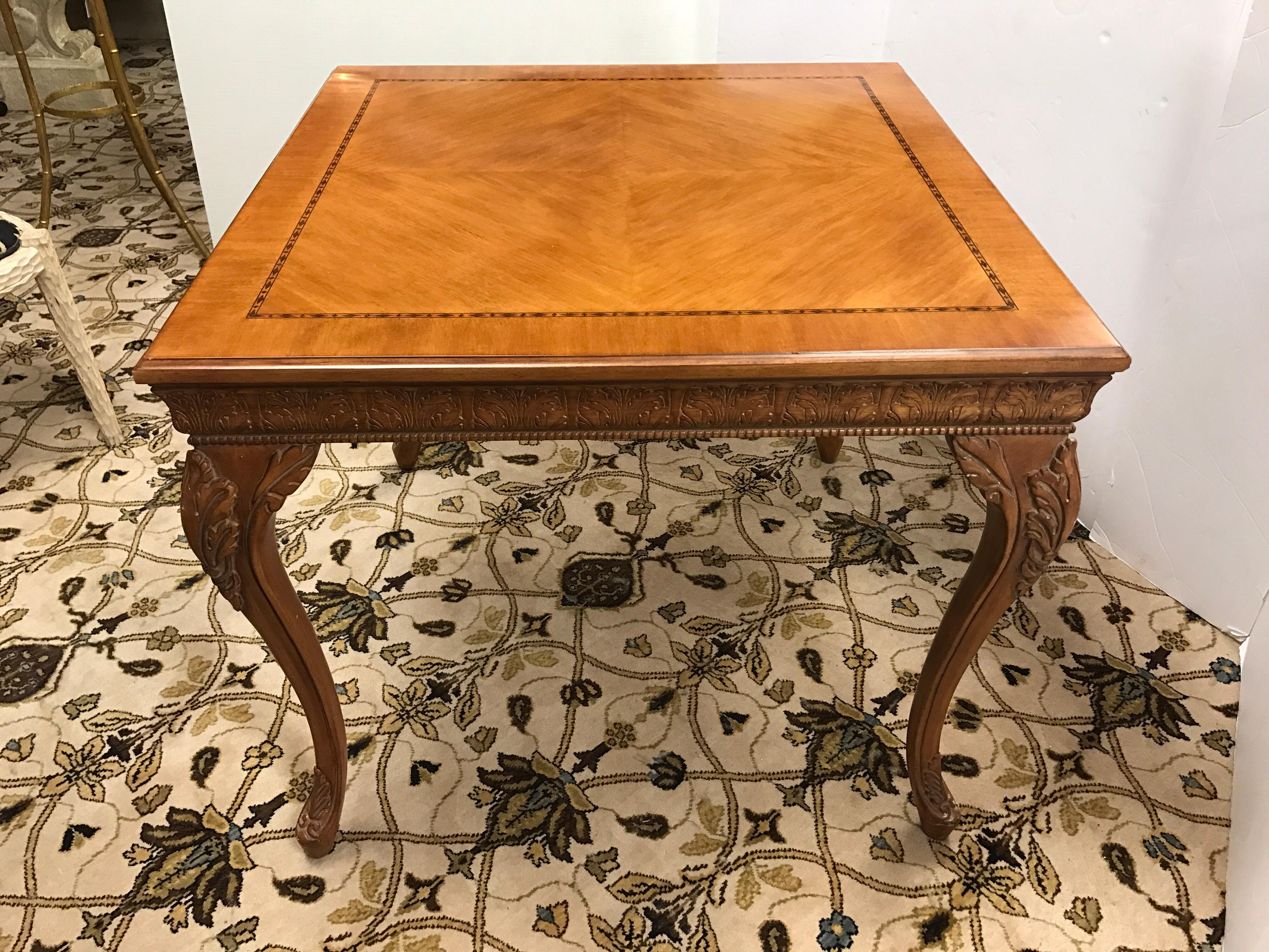 Intricately carved game table done in fruitwood with banding on top and highly carved detail on legs and apron set on delicate cabriole legs.