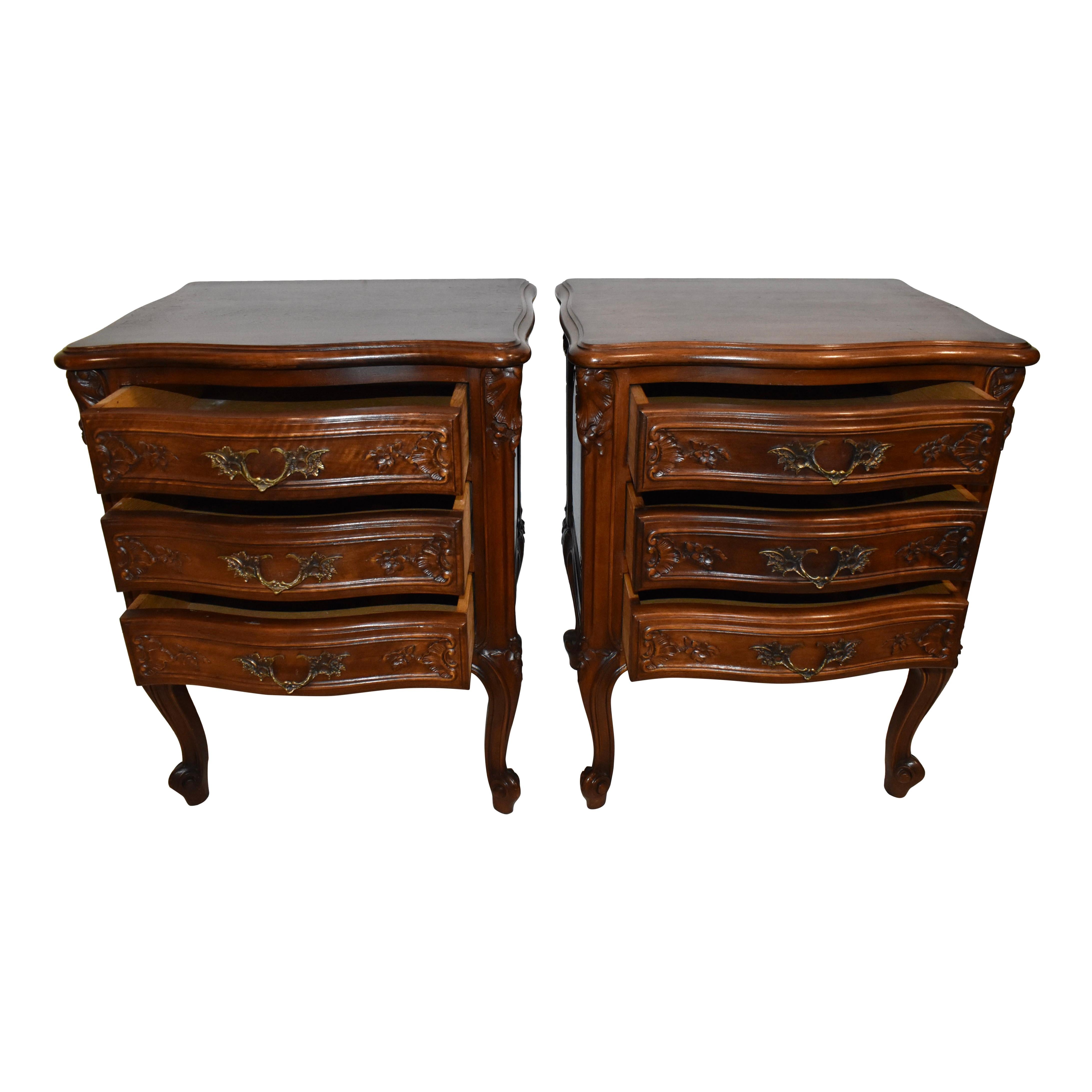 Small in stature but generous is detail and elegance, this pair of nightstands is crafted from walnut and finished with a medium stain that does not hide its luxurious, tight wood grain. Featuring beveled tops with serpentine fronts and sides over