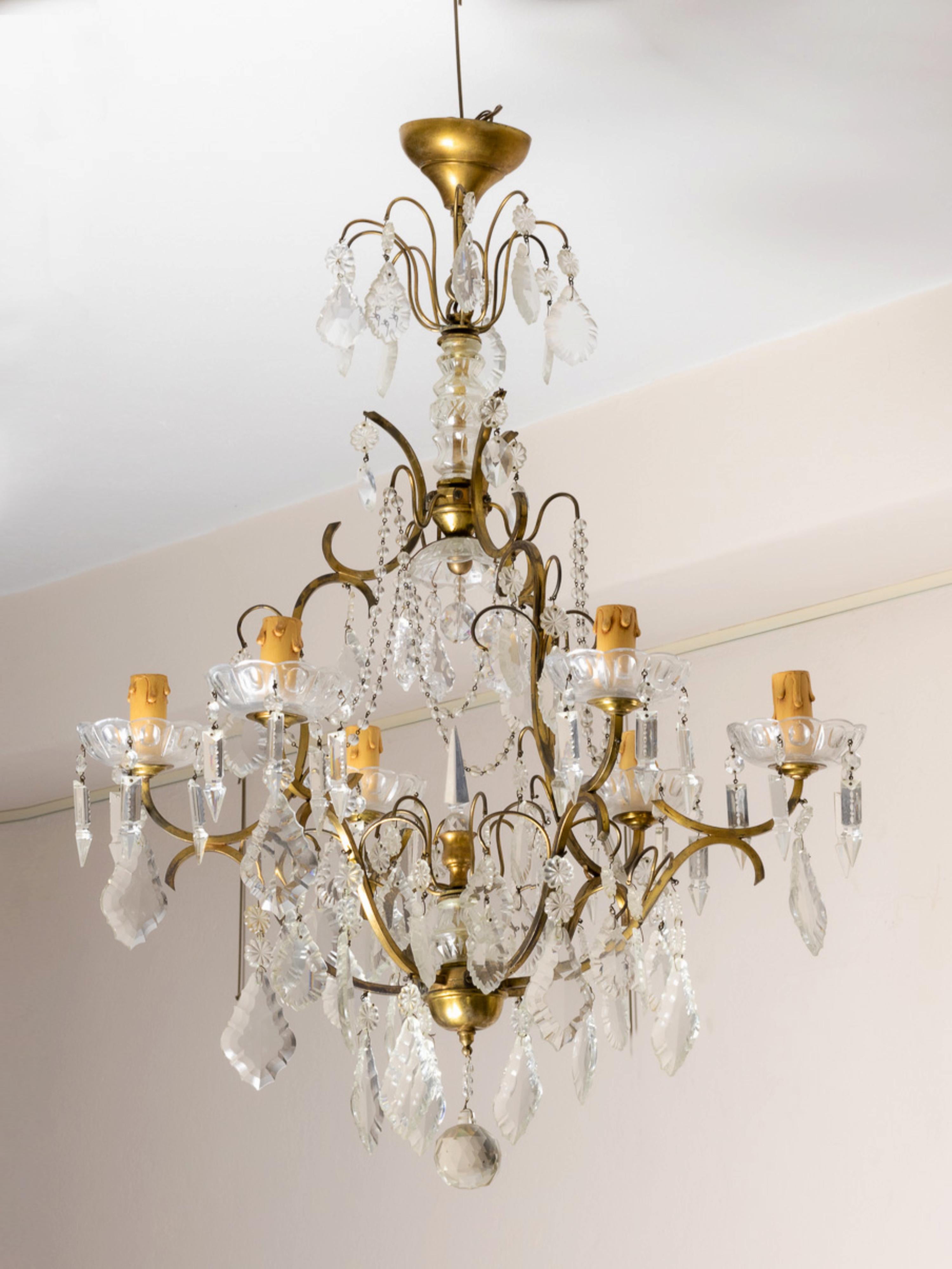 A french Louis XV Style bronze and crystal chandelier with various crystal and glass pendants and finials, six candlestick holders fully rewired and six light sockets.
A magnificent light bringer for any grand room.

The chandelier is currently