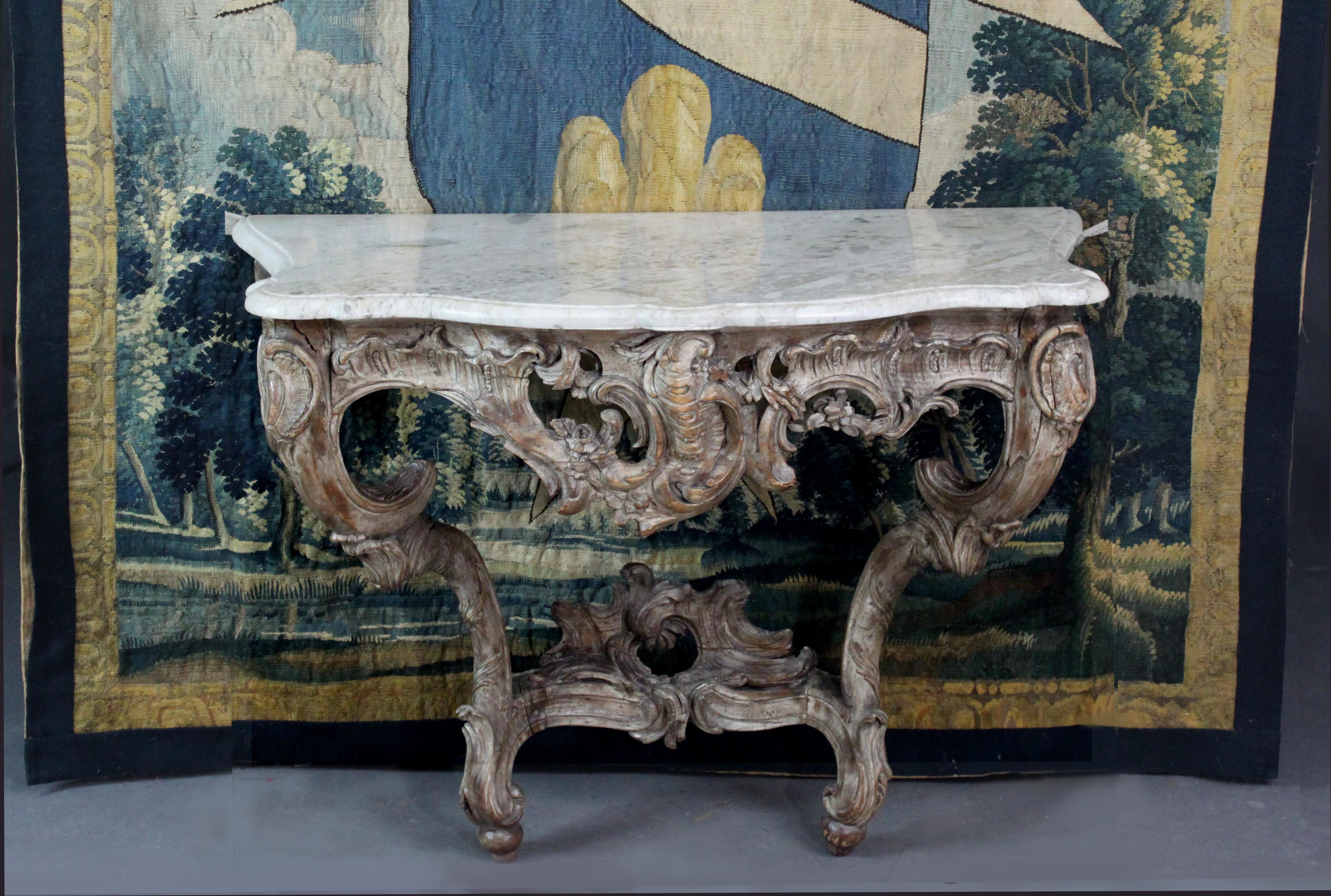 Ein Louis XV-Konsolentisch mit gut geschnitztem Dekor aus Rokoko-Rollen, Blumengirlanden und Blättern. Ursprünglich war es wohl vergoldet, doch die Reste des Gesso verleihen ihm ein attraktives graues Finish, bei dem das Holz des Obstbaums an