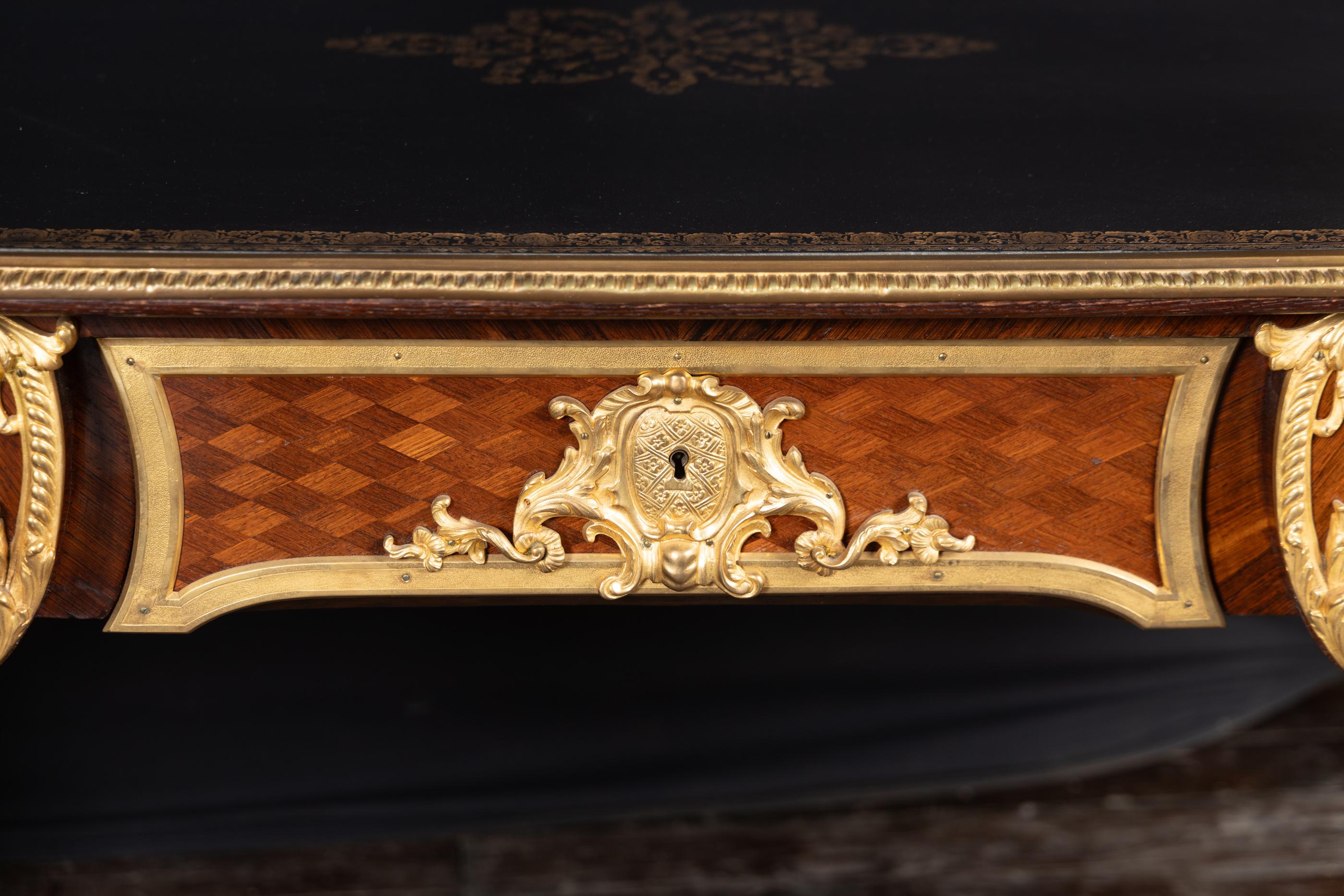 This French Louis XV marquetry bureau plat dates back to the 19th century and is attributed to the artist 